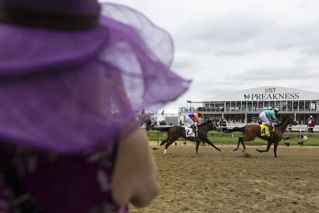 Horses pass during a race on Black Eyed Susan Day at Pimlico Race Course on May 17, 2024.