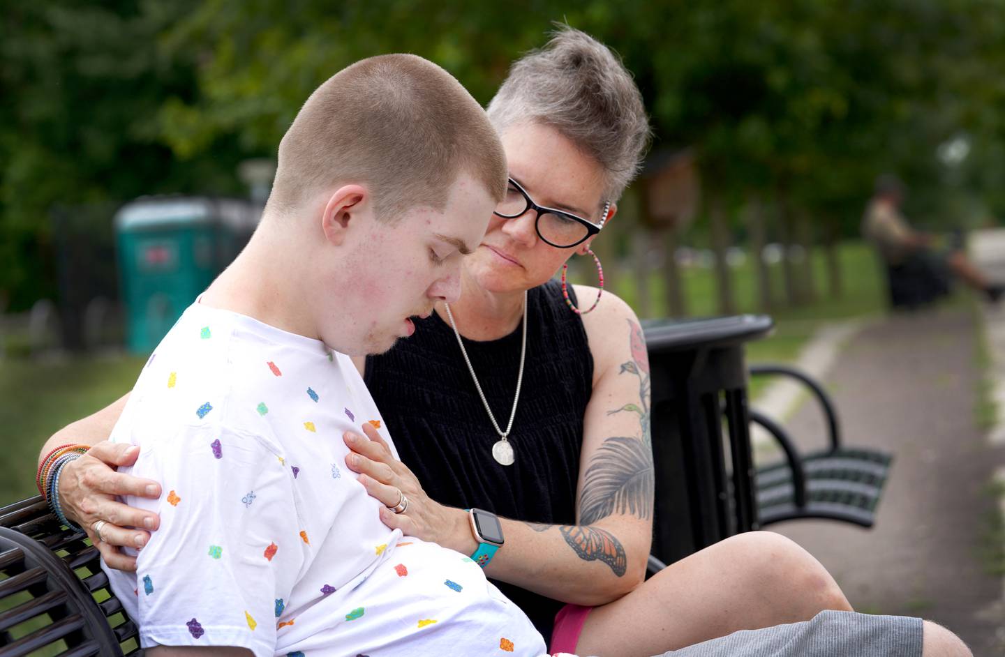 Noah Godfrey takes a moment to rest on a bench with his mother, Sunday Stilwell, in Glasgow Regional Park in Delaware.
