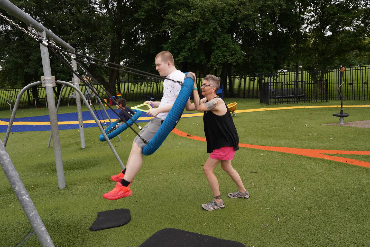 Sunday Stilwell pushes her son, Noah Godfrey, in a swing in Glasgow Regional Park in Delaware.