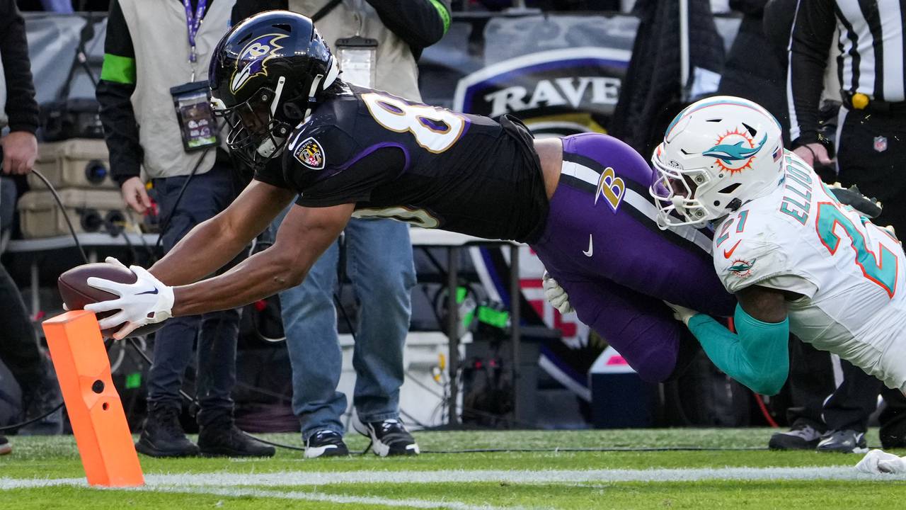 Baltimore Ravens tight end Isaiah Likely (80) extends his arms to score a touchdown against the Miami Dolphins at M&T Bank Stadium on Sunday, December 31, 2023. The Ravens won, 56-19, to secure the best record in the AFC.