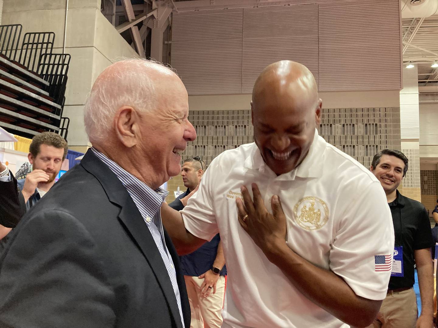 U.S. Sen. Ben Cardin, left, and Gov. Wes Moore share a laugh in the exhibition hall at the Maryland Association of Counties summer conference in Ocean City on Aug. 18, 2023.