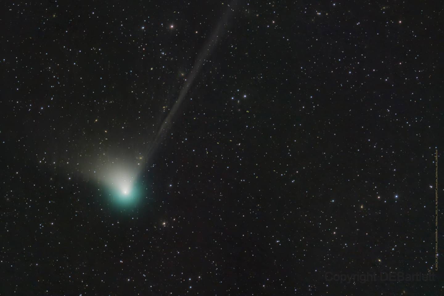 Comet C/2022 E3 (ZTF) was discovered by astronomers using the wide-field survey camera at the Zwicky Transient Facility this year in early March. This fine telescopic image from December 19, 2022, shows the comet's brighter greenish coma, short broad dust tail, and long faint ion tail
