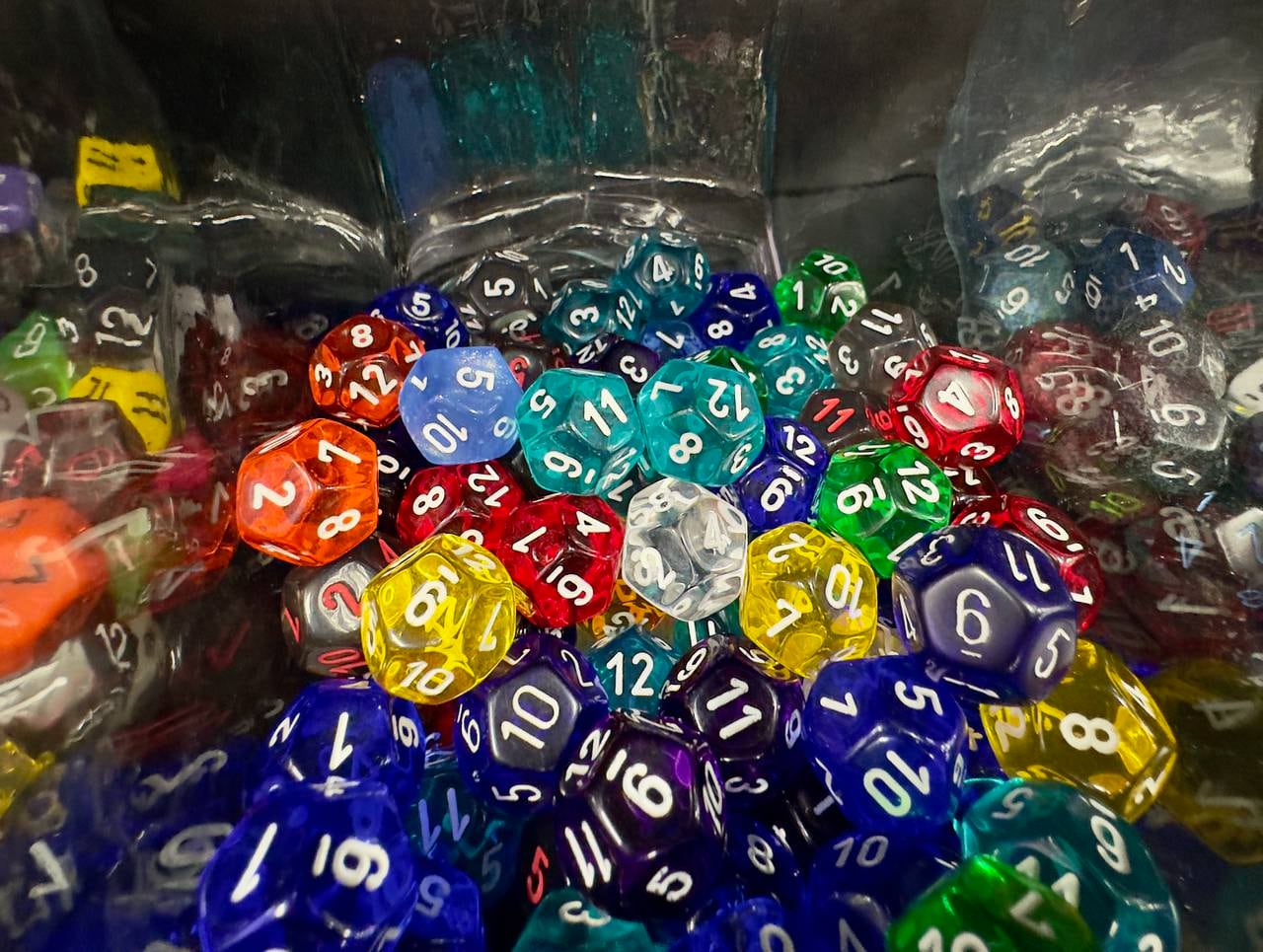 Container full of multicolored 12-sided dice at Games and Stuff in Glen Burnie.