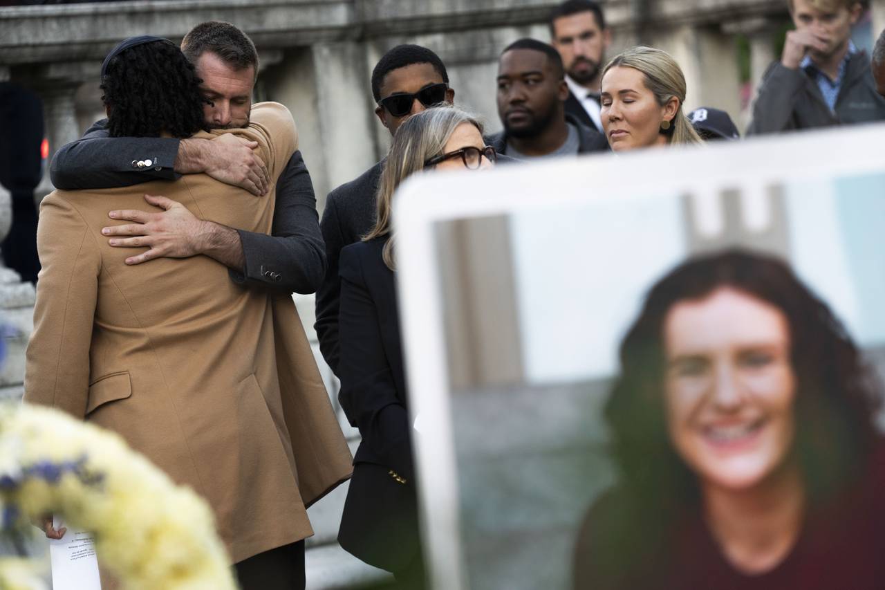 Nick Culbertson, close friend of Pava LaPere’s, hugs Kory Bailey, another close friend, during a vigil held in her honor at the Washington Monument in Mount Vernon on Sept. 27, 2023.