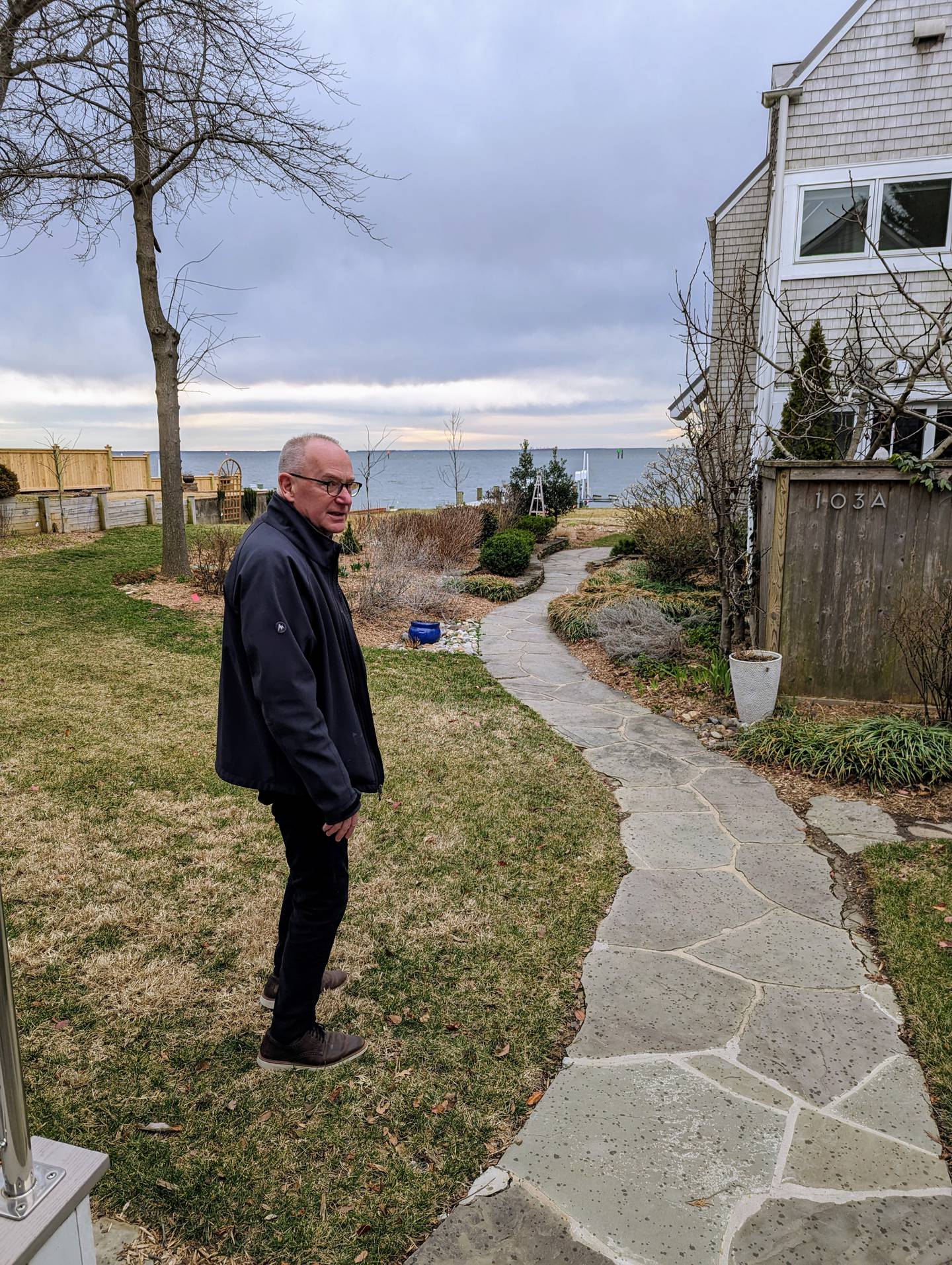 Jeffrey Eckel at his new home in Eastport. He bought the waterfront house, and then ripped out all gas appliances in an effort to get it to net zero carbon emissions.