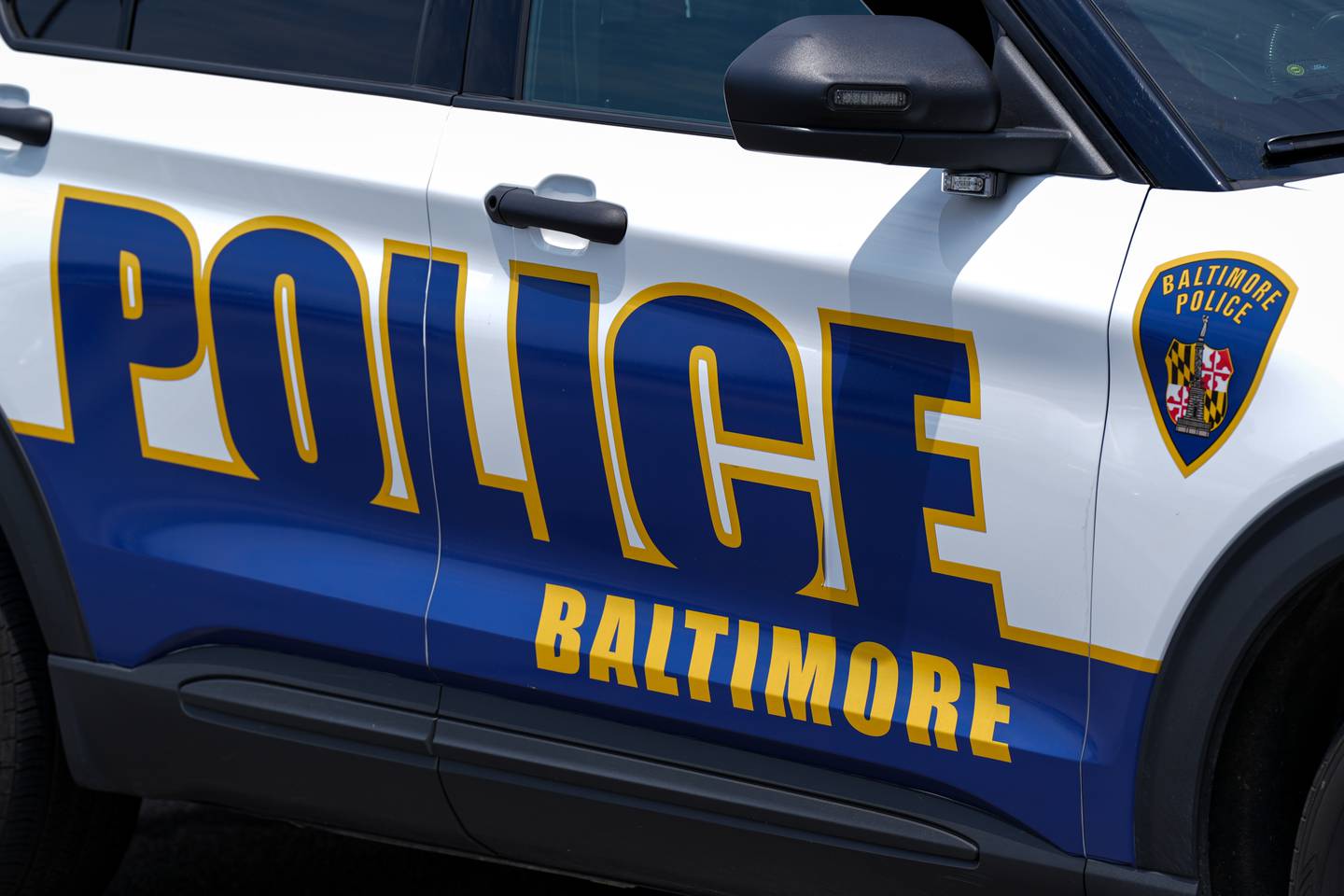 6/22/22—Police investigate a crime scene where three men were shot in a Northeast Baltimore shopping center Wednesday morning.