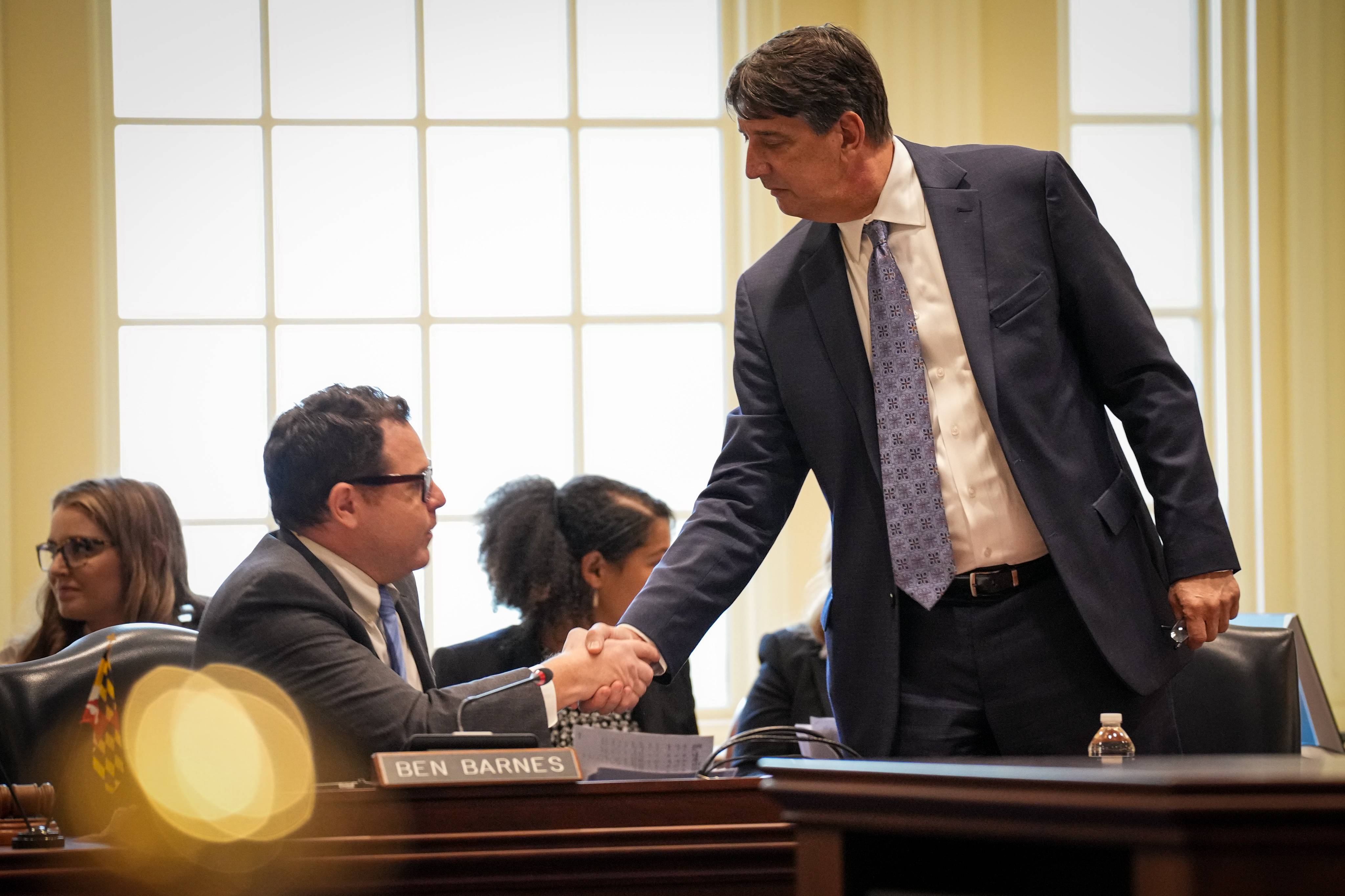 Del. Ben Barnes and Sen. Guy Guzzone shake hands after reaching agreement on the details of the state's budget on Friday, March 31.