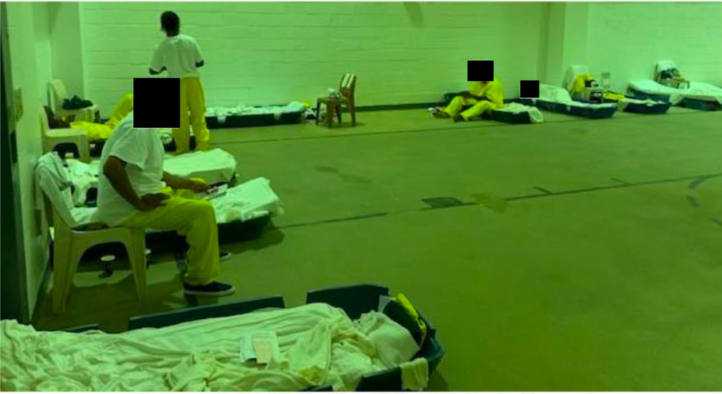 Photographs taken during an August tour of the Baltimore Central Booking and Intake Center and its medical infirmary show men in a temporary dorm sleeping on plastic "boats" in a gymnasium.