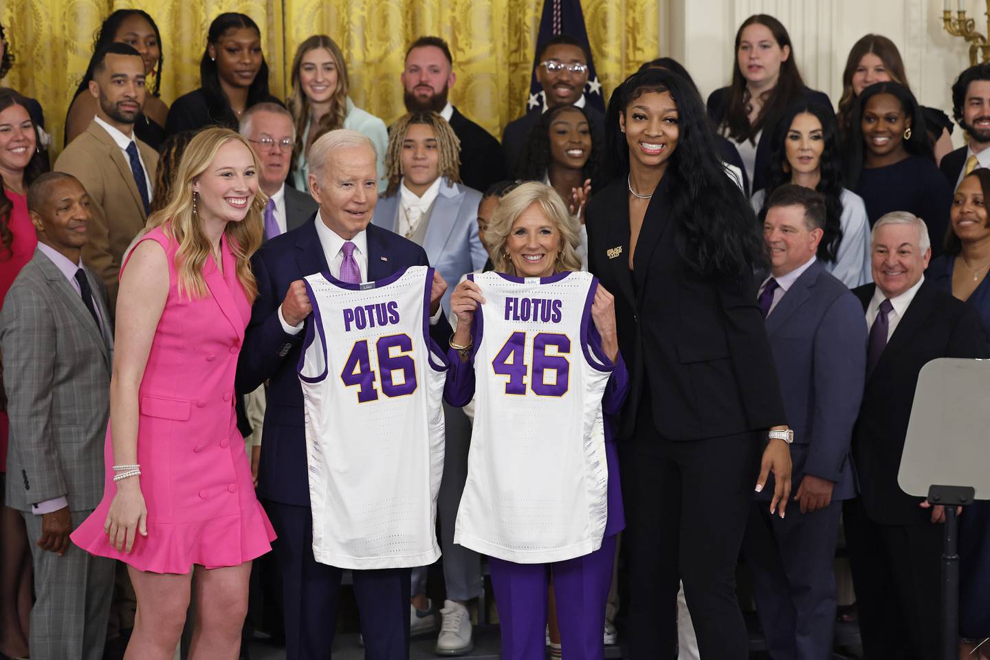 WASHINGTON, DC - MAY 26: U.S. President Joe Biden and first lady Jill Biden pose for photographs with co-captains Emily Ward (L) and Angel Reese during a celebration for the Louisiana State University NCAA Division I women's basketball national championship team in the East Room of the White House on May 26, 2023 in Washington, DC. Under the leadership of head coach Kim Mulkey, the LSU Tigers defeated Iowa 102-85 to win their first national championship.