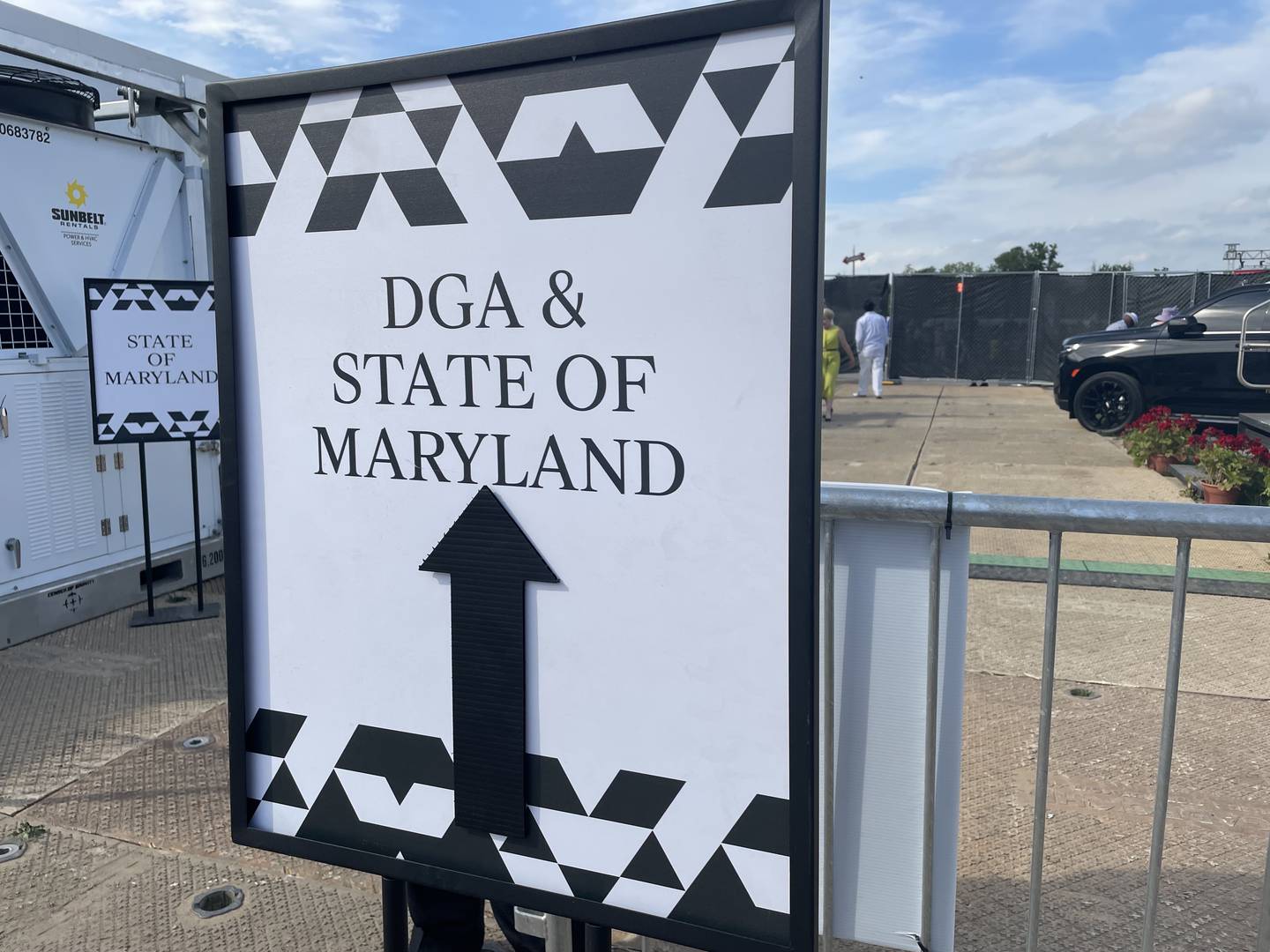 A sign points the way to private hospitality tents hosted by the Maryland state government and the Democratic Governors Association at Pimlico Race Course for Preakness 148 on Saturday, May 20, 2023.