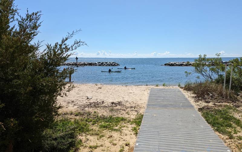 A sand mat forms a walkway across fragile beaches to the water at Beverly Triton Nature Park.