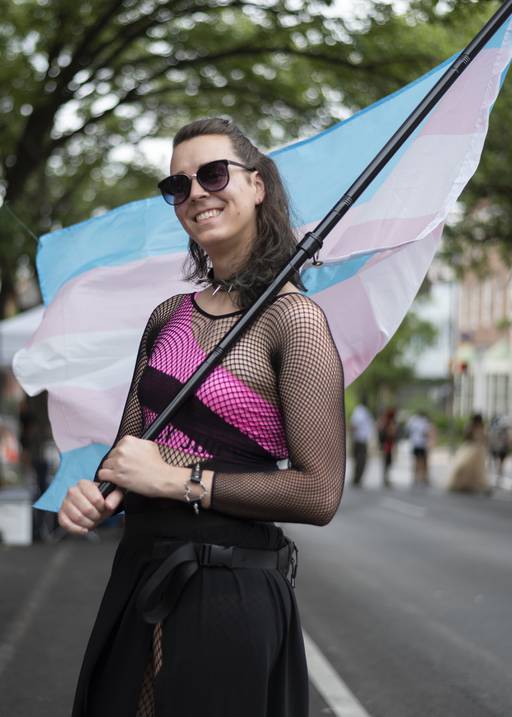 Ember Behrends waves a trans flag at Trans Pride in Baltimore on June 3, 2023.