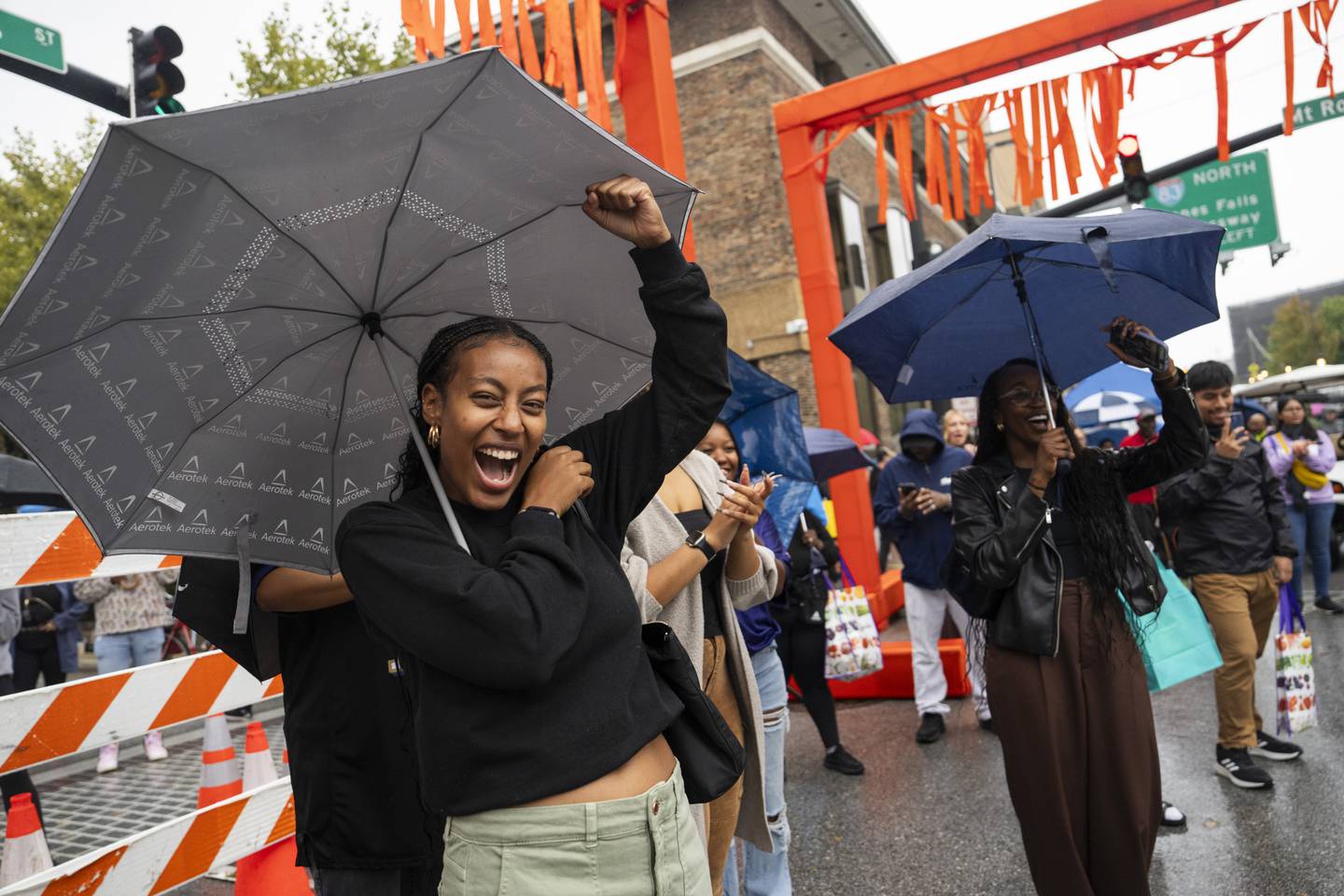 Einaton Amare cheers while the Greater Baltimore Church puts on a musicial performance and dance in the rain at Artscape on September 24, 2023.