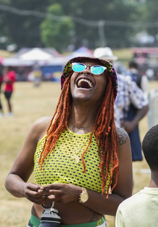 Shay Lyseh, 28, laughs at AFRAM Juneteenth Festival on June 17, 2023 at Druid Hill Park. This is the first official Baltimore Club Music Day.