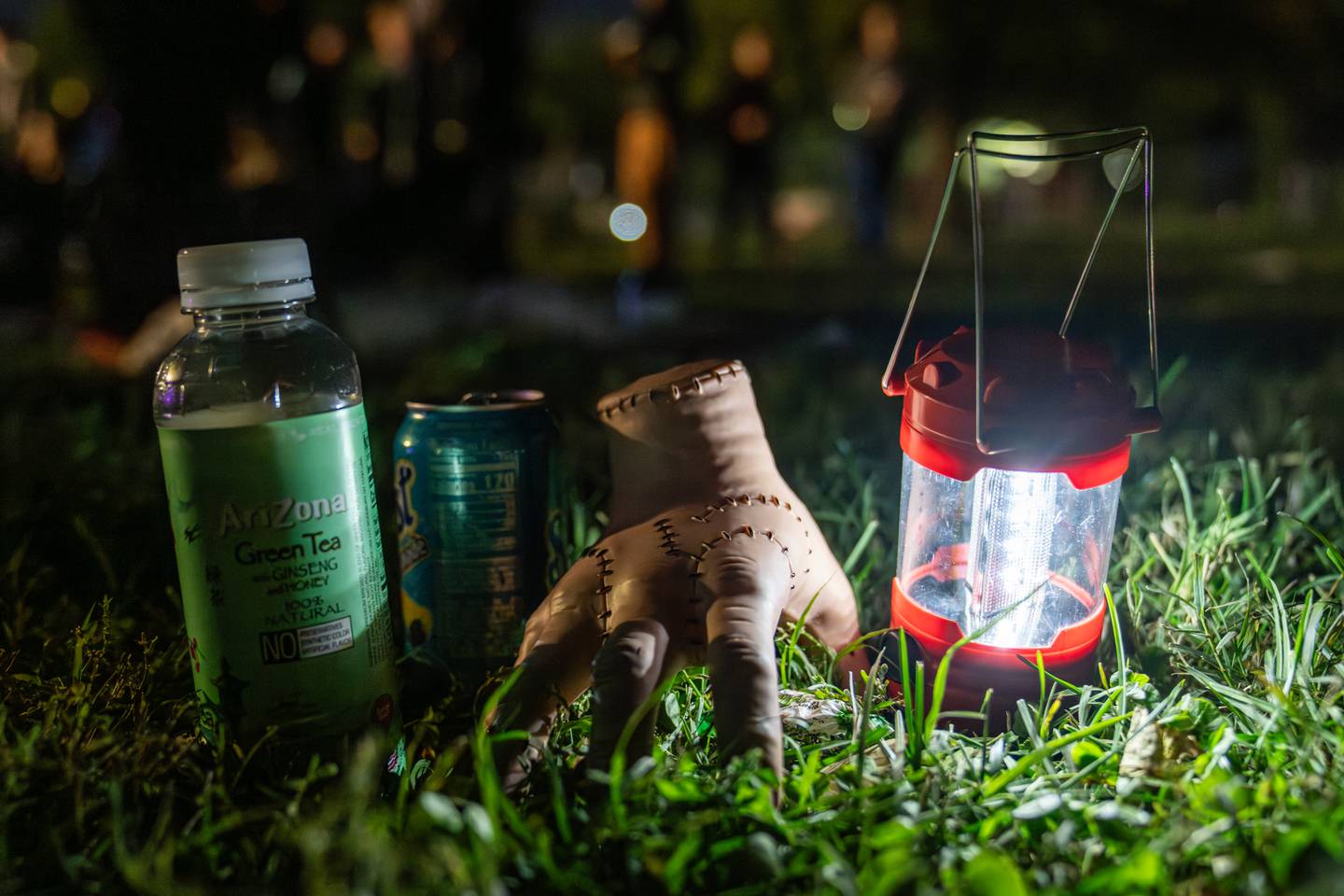 A prop hand lies in the grass during The Great Halloween Lantern Parade & Festival at Patterson Park on Saturday, Oct. 21, 2023.