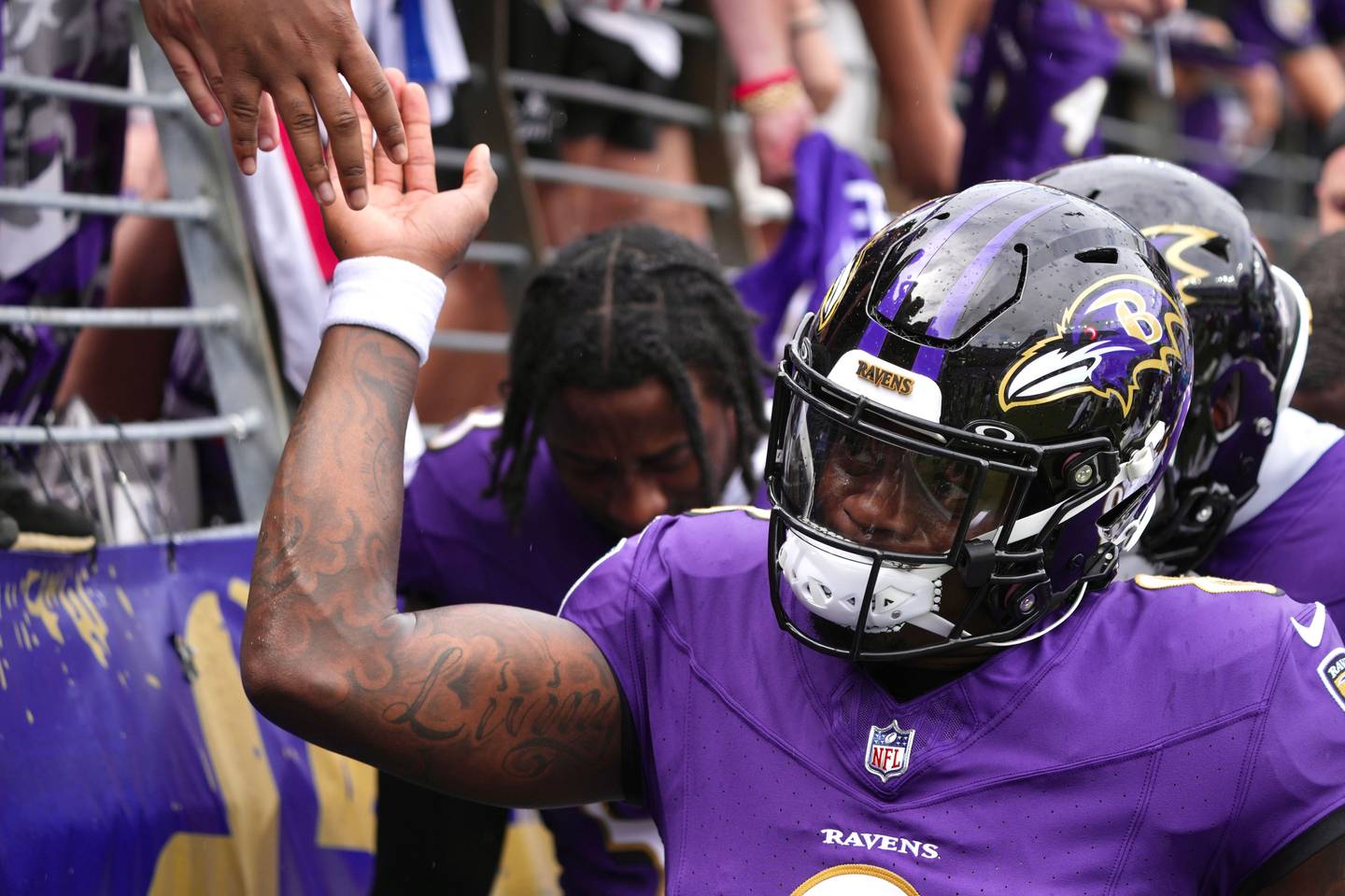 Ravens quarterback Lamar Jackson slaps hands with fans at M&T Bank Stadium before the Ravens face the Texans in the season opener against the Houston Texans.