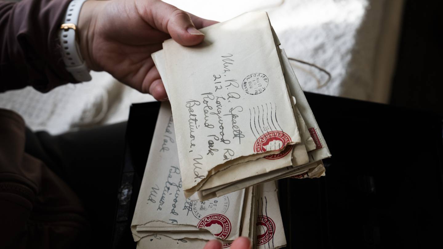 Joanna Meade reads aloud love letters from the 1920's in the sun room of her home on February 27, 2024. The letters were found inside of a wall during a renovation.