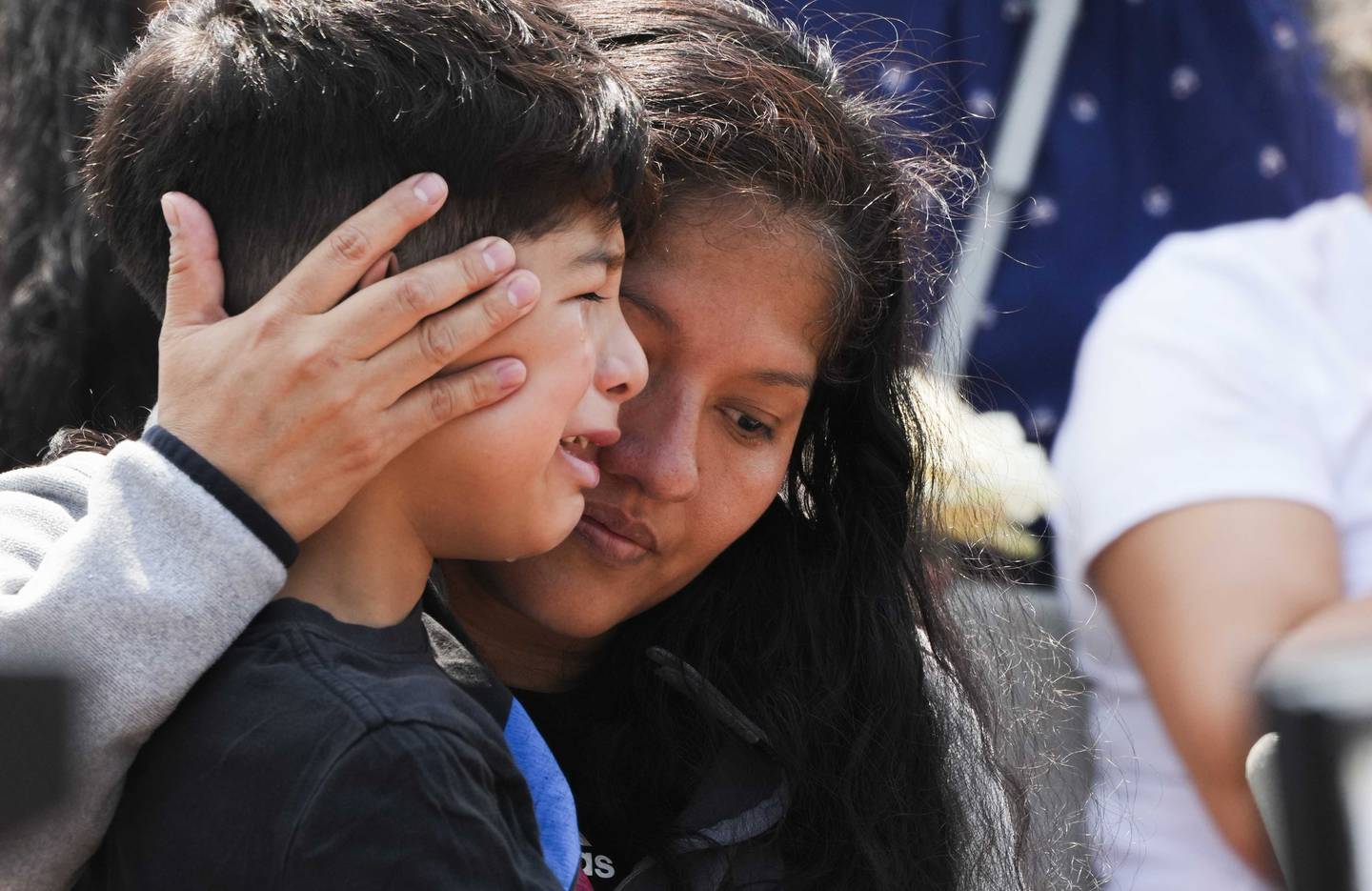 Sandra Mireles, wife of Nicholas Mireles, 55, hugs their son at a vigil on June 18, 2023. Mireles was killed in a mass shooting on June 11.