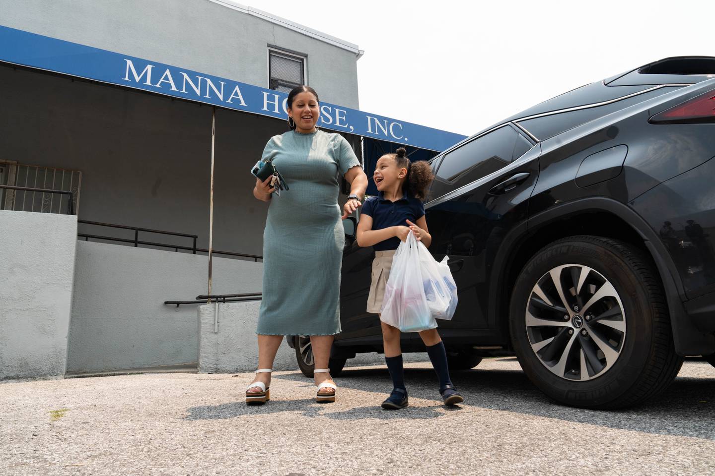 Tatum Byerson steps out of the car with her mother, Danielle Byerson, to donate goods to Manna House on Wednesday, June 7, 2023.