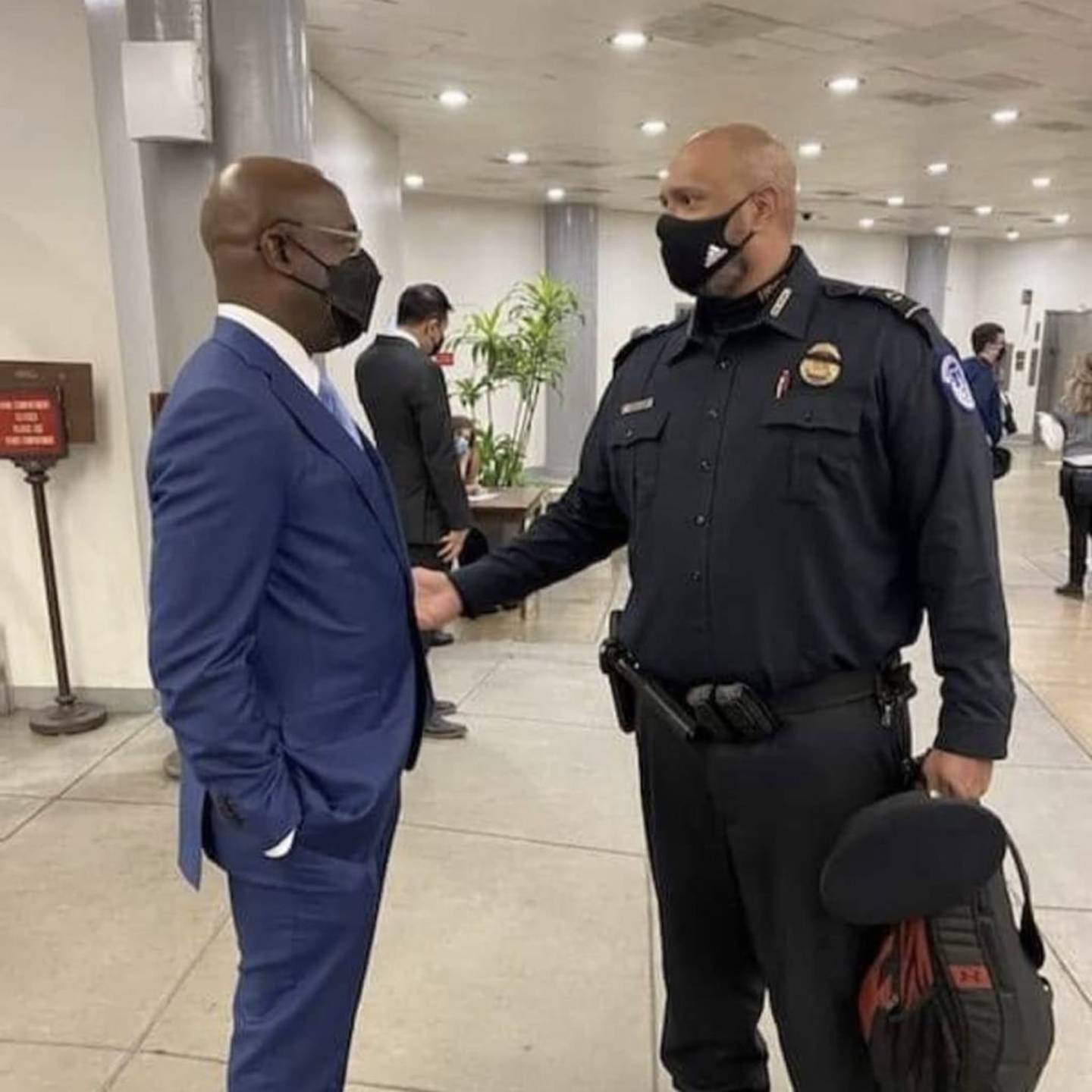 Capitol Police Officer Harry Dunn (right) greets Georgia Sen. Raphael Warnock, who he helped raise money for over the weekend with a series of fun "Thirst Tweets."