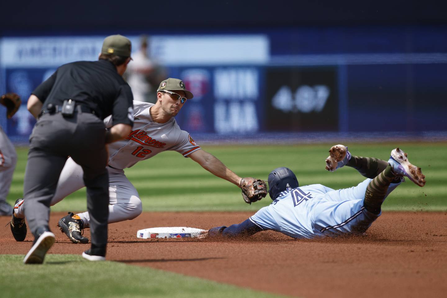 George Springer #4 of the Toronto Blue Jays steals second base from Adam Frazier #12 of the Baltimore Orioles in the first inning of their MLB game at Rogers Centre on May 21, 2023 in Toronto, Canada.