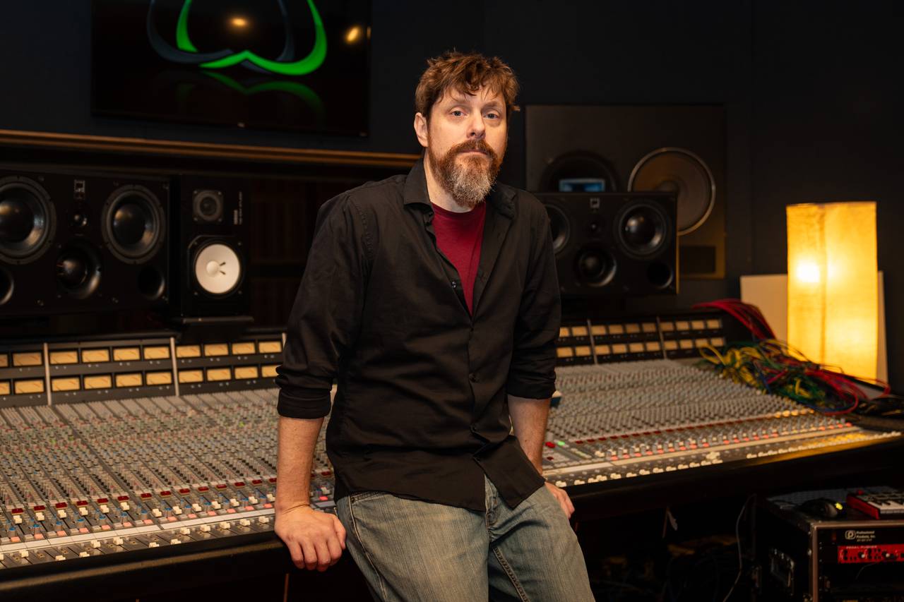 Steve Wright leans against the mixing console in Studio A for a portrait.