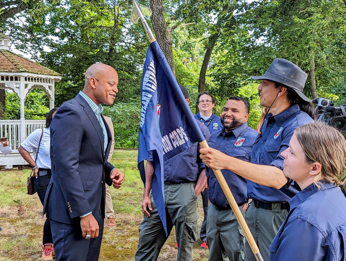 Gov. Wes Moore, left, talks with members of the Maryland Conservation Corps at the Wye Island Natural Resources Management Area on Thursday, July 20, 2023.