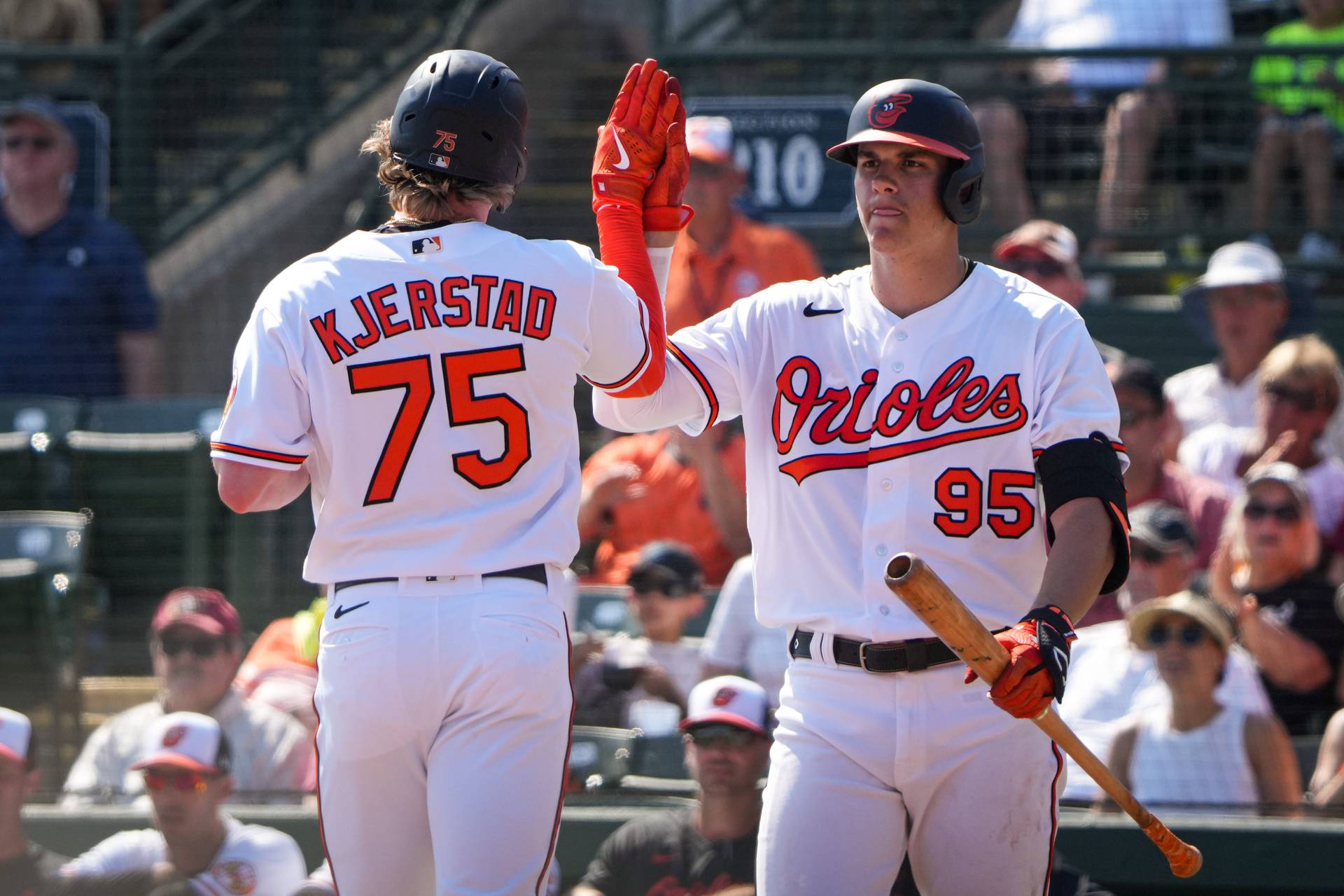 Heston Kjerstad (75) high fives Coby Mayo (95) at Ed Smith Stadium after scoring a run during the fourth inning of a game against the Minnesota Twins on 2/25/23. The Baltimore Orioles hosted the Twins for their home opener as the Florida Grapefruit League started on Saturday.