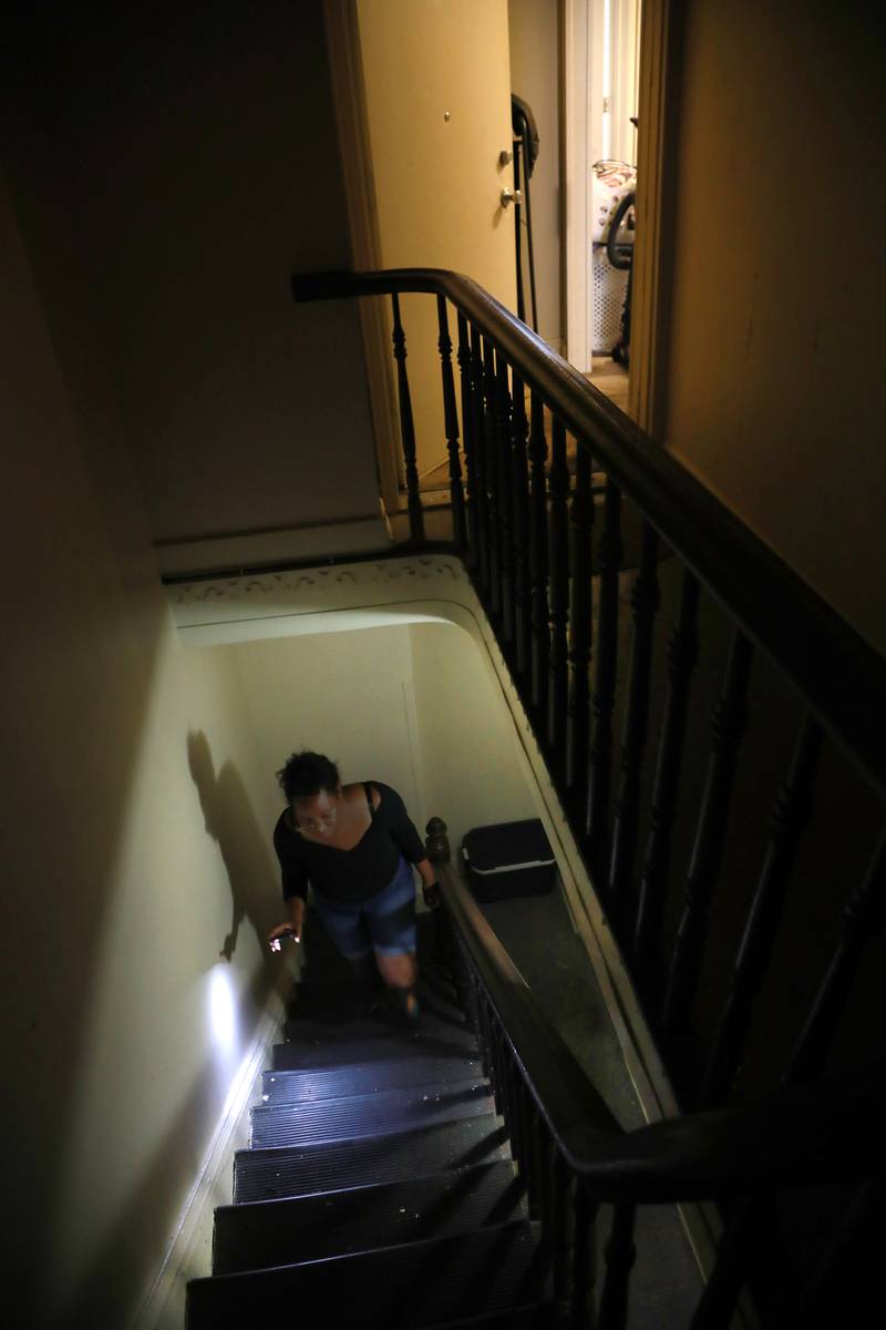 Records show a Baltimore nonprofit housing provider stopped paying tenants’ rents and hasn’t accounted for the money. The light at the top of the stairwell is out. Residents use a flashlight or their mobile phone light to get around.