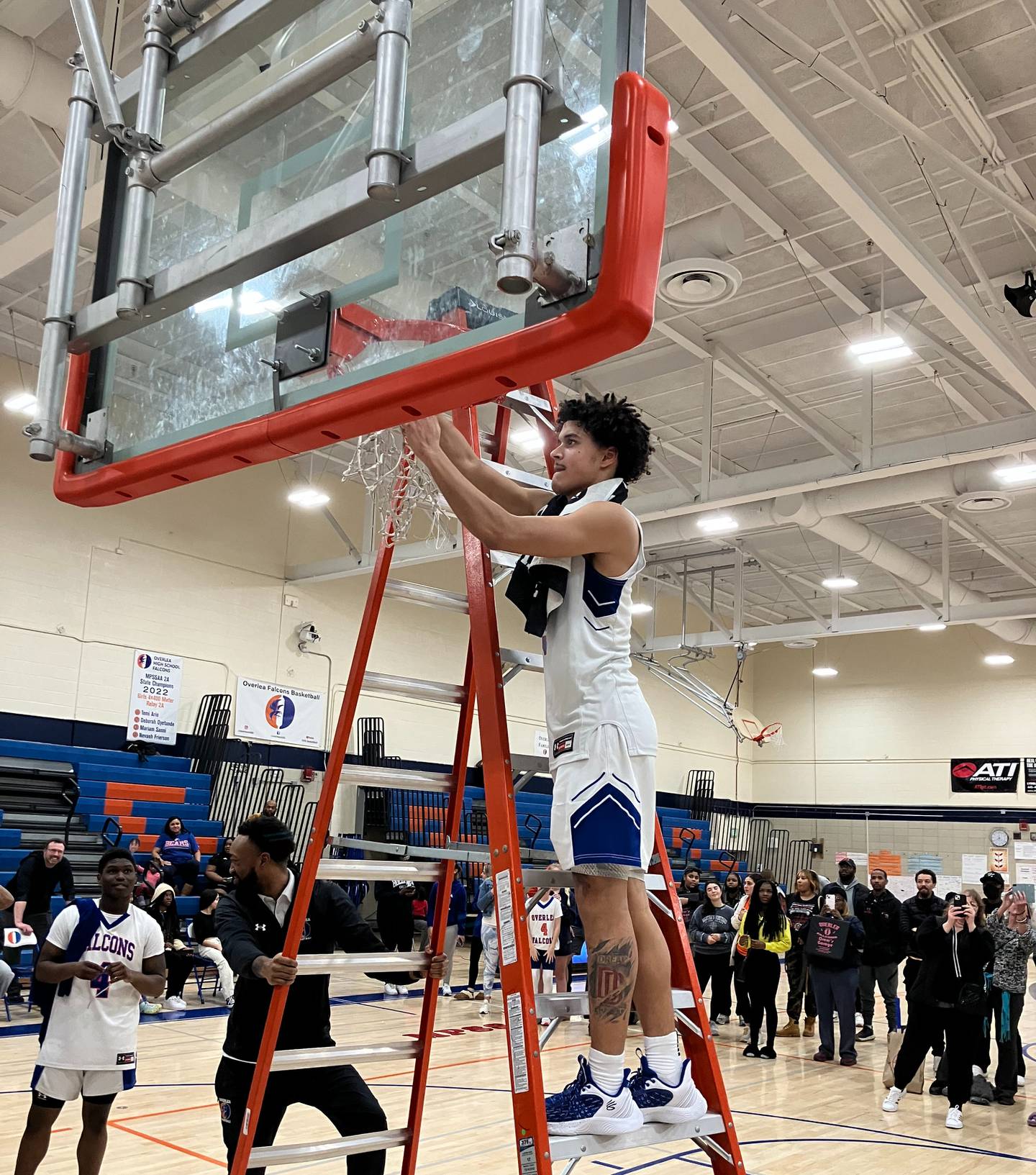 Overlea's Tjay Backles cuts down some of the basketball net after Thursday's Class 2A North Region 2 championship game. Backles scored 11 of his 23 points in the final quarter as the Falcons top Carver Vo-Tech to advance to Saturday's state quarterfinals.