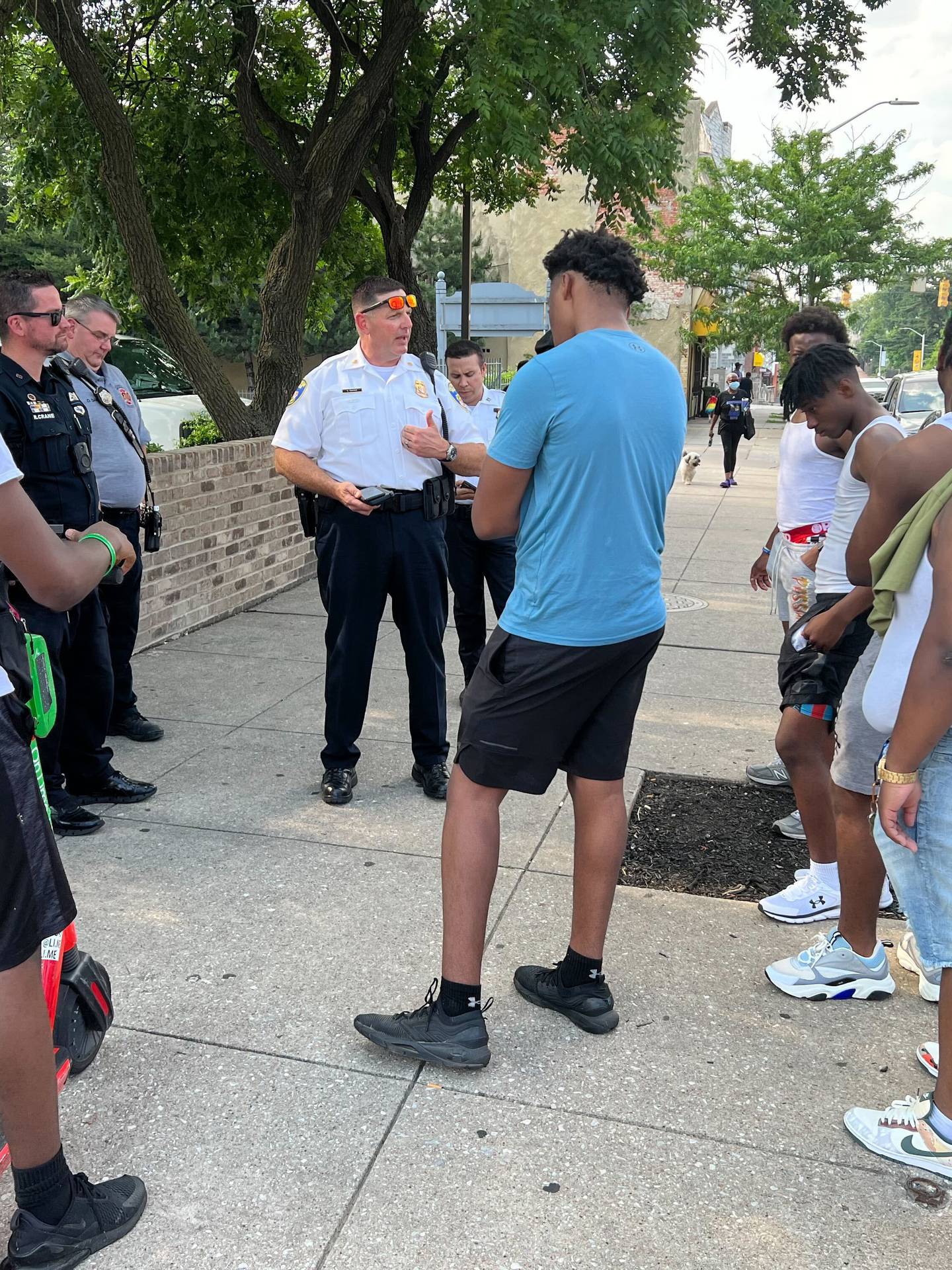 Eastern District Maj. Guy Thacker, middle, speaks to a group of young men frustrated that the city blocked their efforts to throw a party on Mura Street. Officials spent a week trying to thwart the party based on concerns from neighbors.