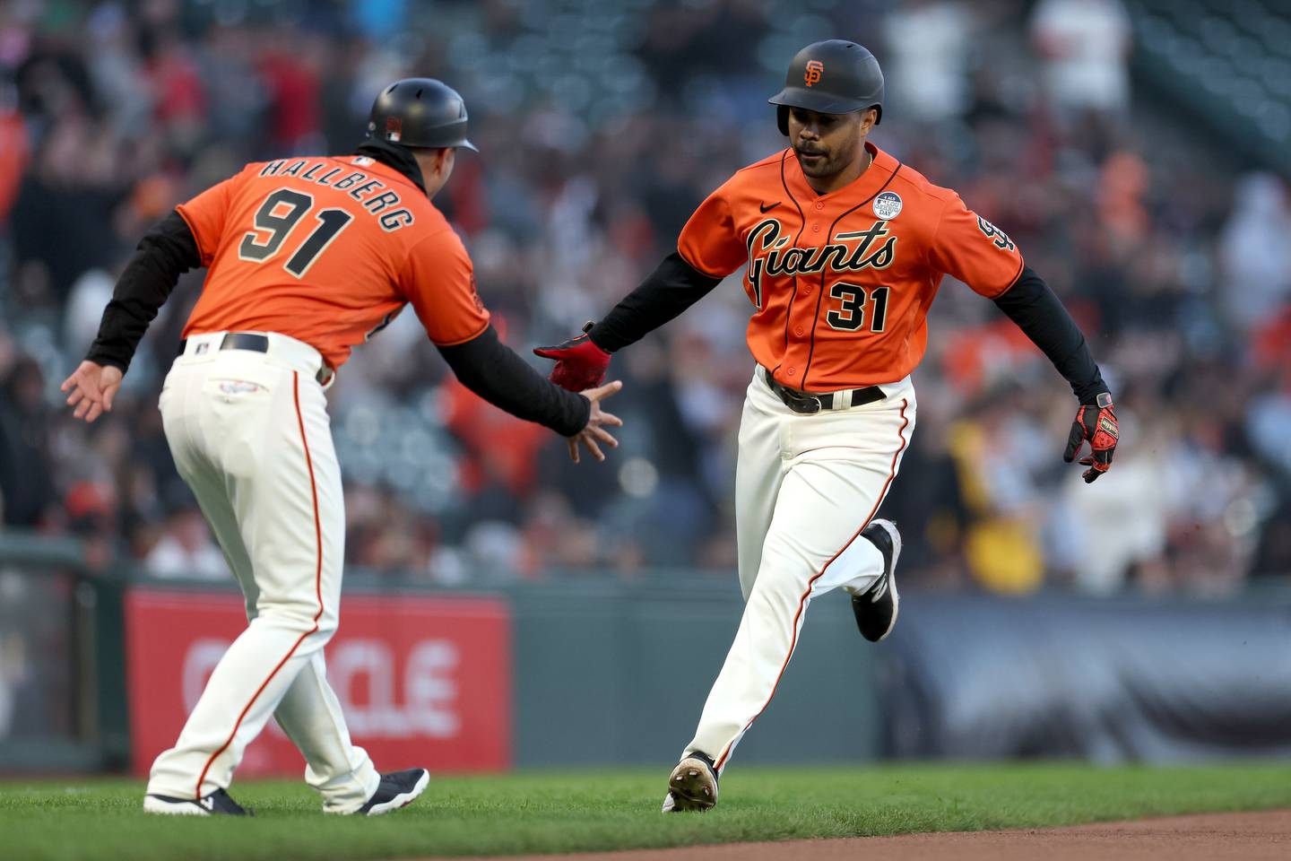 SAN FRANCISCO, CALIFORNIA - JUNE 02: LaMonte Wade Jr. #31 of the San Francisco Giants is congratulated by Mark Hallberg #91 as he rounds the bases after hitting a lead-off home run against the Baltimore Orioles in the first inning on June 02, 2023 in San Francisco, California.