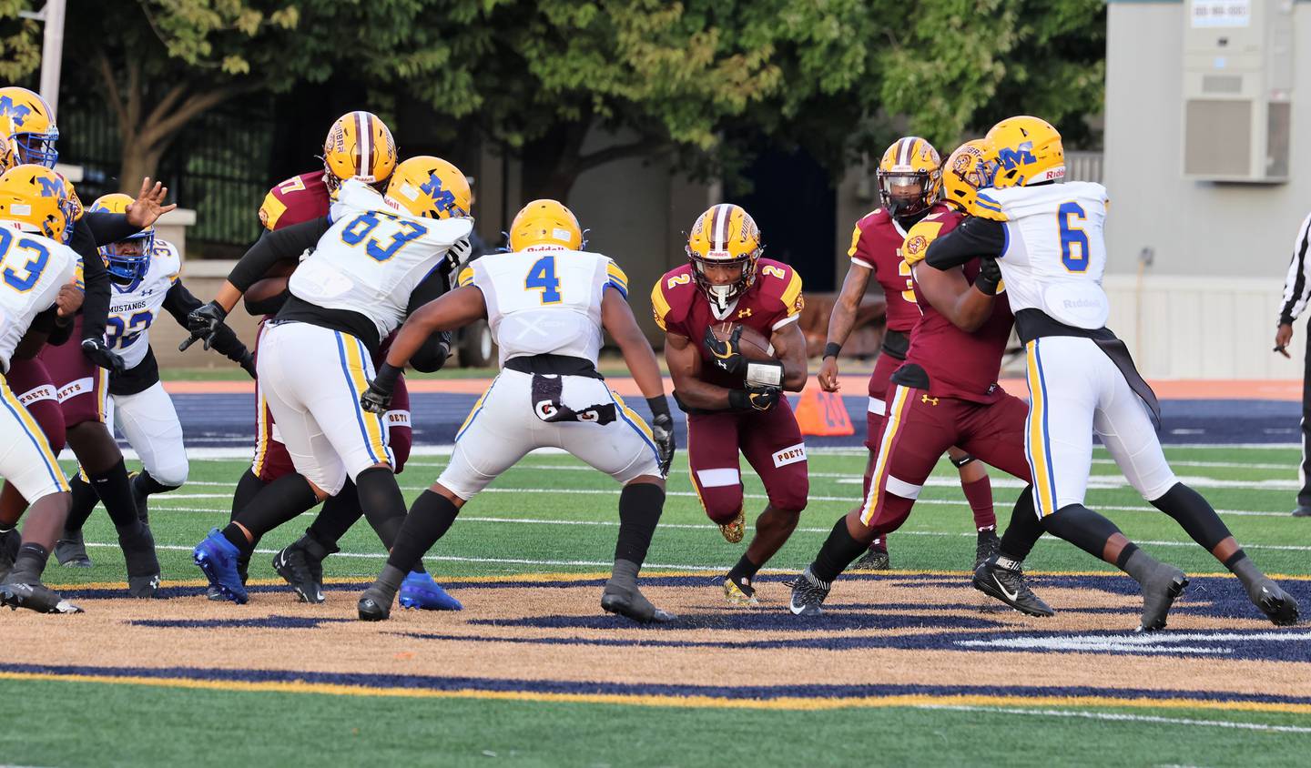 Dunbar's Tristen Kenan looks for running space during Thursday's Baltimore City football game against Mervo. Kenan scored twice as the No. 6 Poets defeated the seventh-ranked Mustangs, 24-20, in front of nearly 6,500 at Morgan State University.