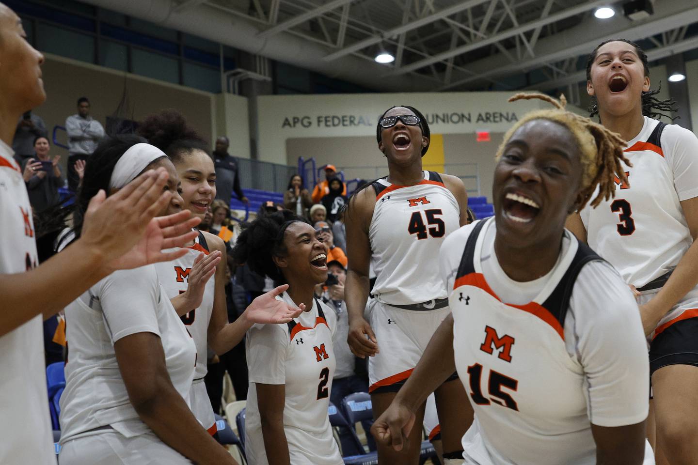 McDonogh players react in celebration following the IAAM A Girls Championship game in Bel Air, Md., on Monday, February 20, 2023. McDonogh defeated St. Frances 50-47 to win the championship.
