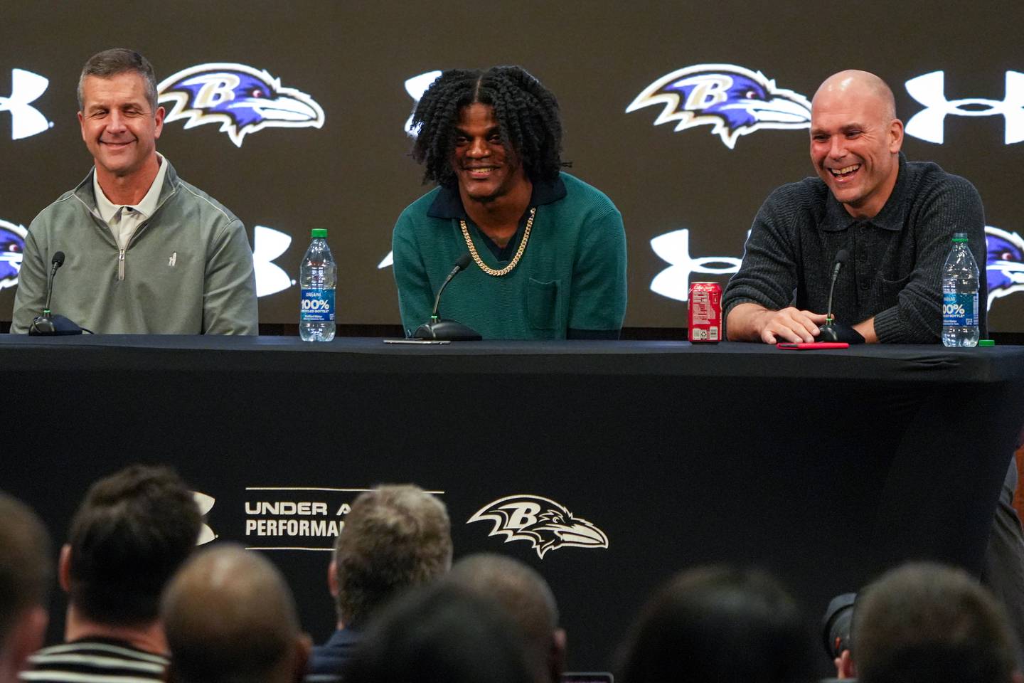 From left: Baltimore Ravens Head Coach John Harbaugh, quarterback Lamar Jackson and General Manager Eric DeCosta laugh as they answer questions during a press conference at the Under Armour Performance Center on Thursday, May 4. Jackson and the Ravens recently came to an agreement on his contract extension, a 5-year deal worth $260 million.