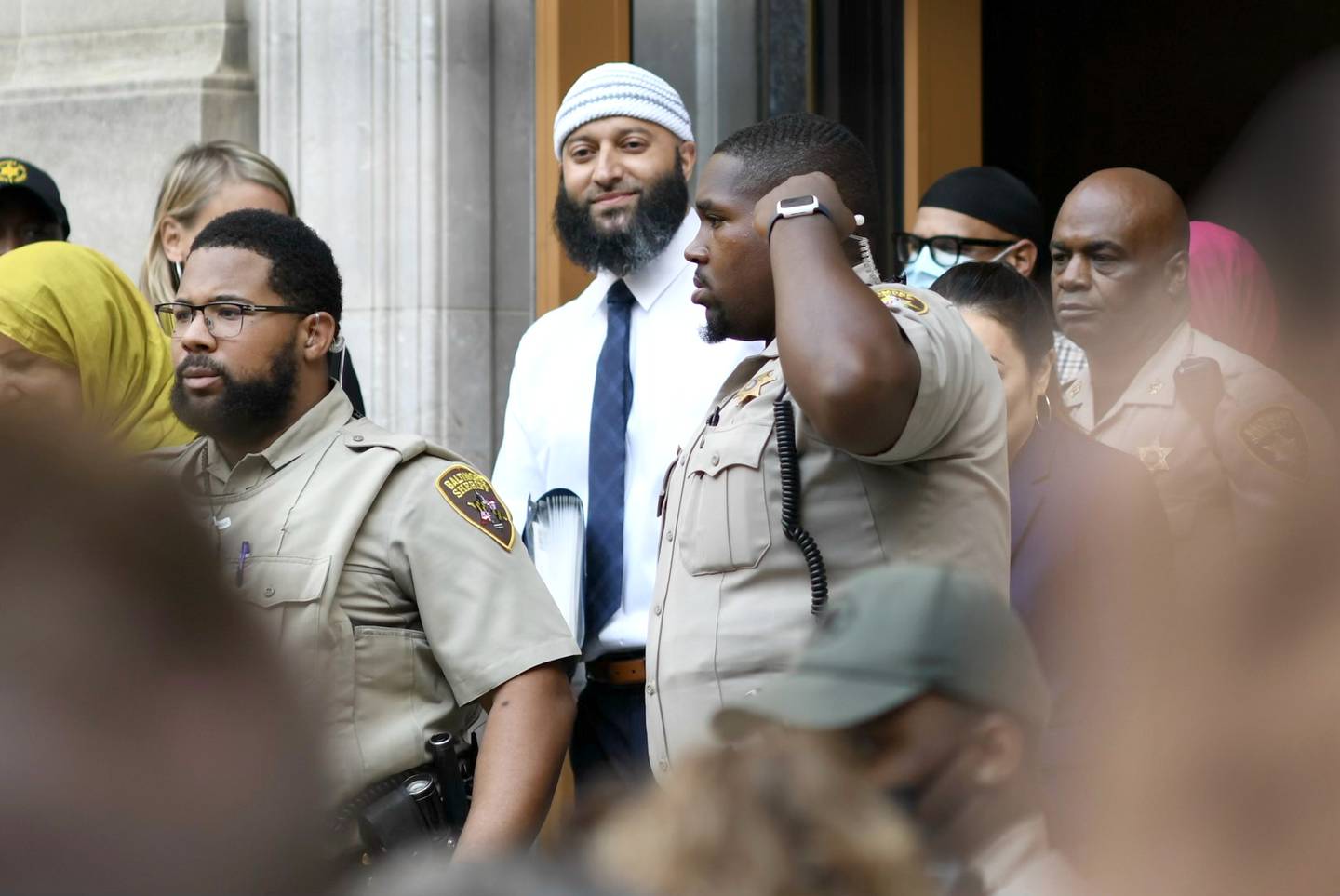 Adnan Syed emerges from the courthouse and after Baltimore Judge Melissa Phinn threw out Syed's murder conviction in light of new evidence that someone else could have strangled Hae Min Lee, ordered the release of  Syed.