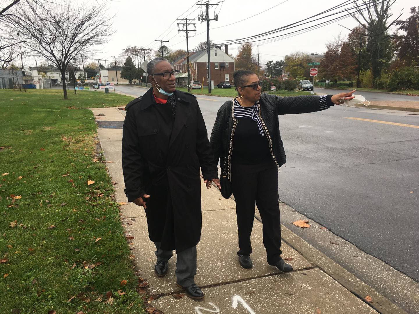 Michael Hancock and Olivia Lomax walk along Sollers Point Road in Turner Station which often floods.