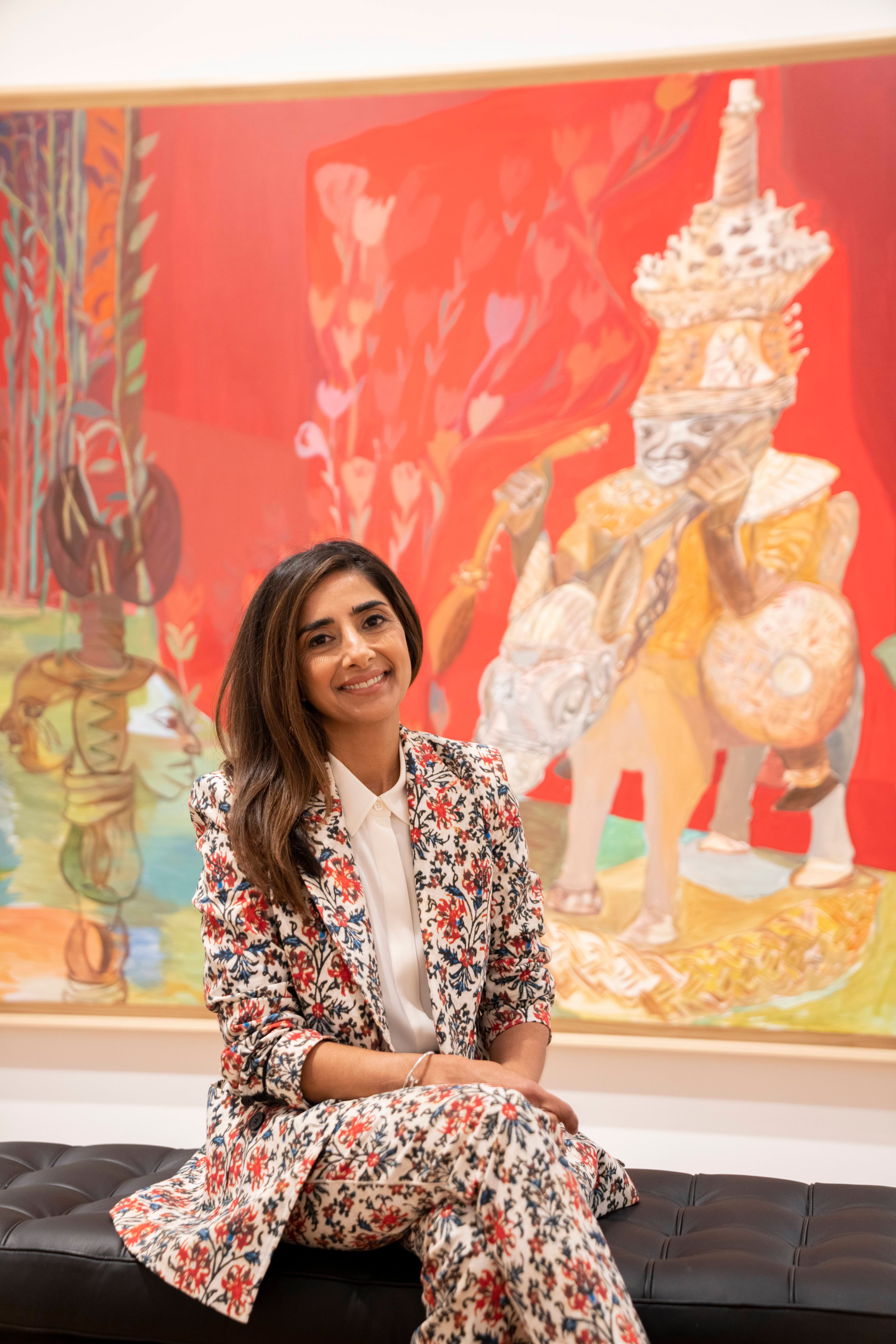 Asma Naeem, The Eddie C. and C. Sylvia Brown Chief Curator, stands in front of recent works on paper by Salman Toor in the exhibition Salmon toor: No Ordinary Love, on view through October 23, 2022.