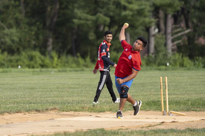 Suman Chhetri, manager, warms up for practice by bowling a few balls on July 27.