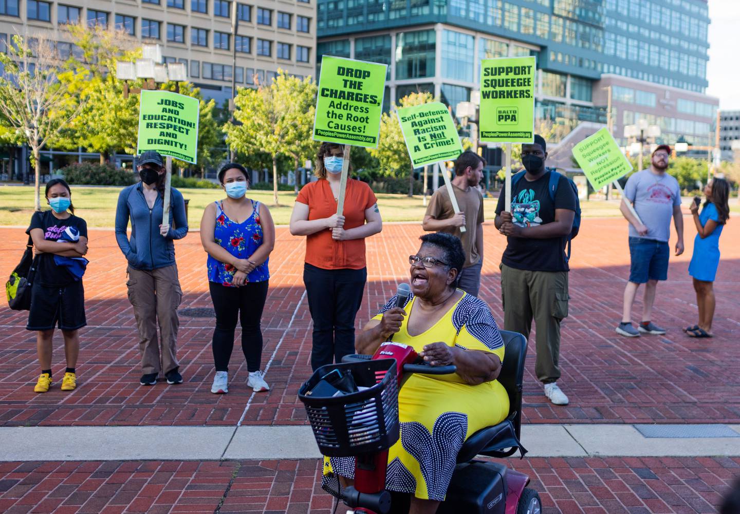 Protesters stand in downtown. Baltimore as part of a squeegee-focused protest following the arrested a 15 year-old worker who allegedly shot, Timothy Reynolds, 48 on July 27, 2022.