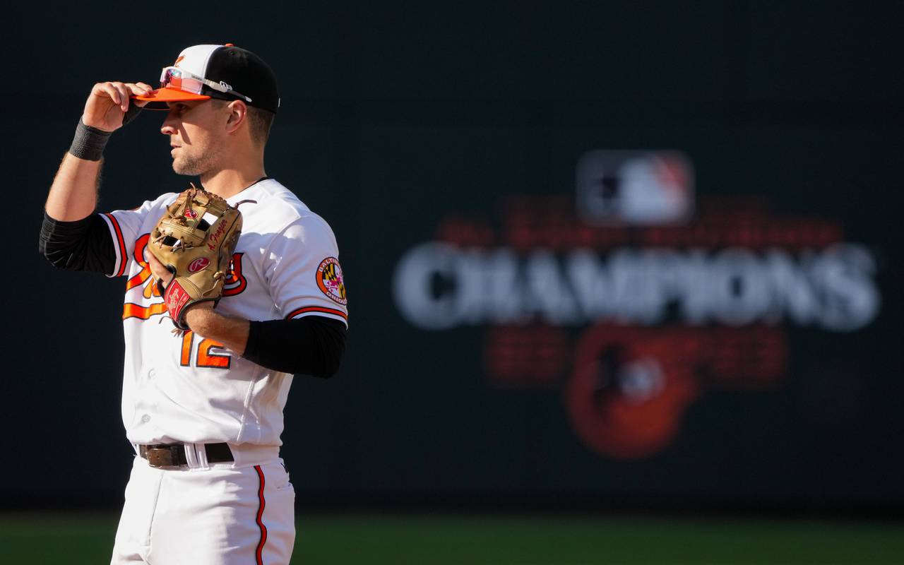 Baltimore Orioles second baseman Adam Frazier (12) adjusts his hat before a pitch is thrown during game one of the American League Divisional Series against the Texas Rangers at Camden Yards on Saturday, October 7, 2023.