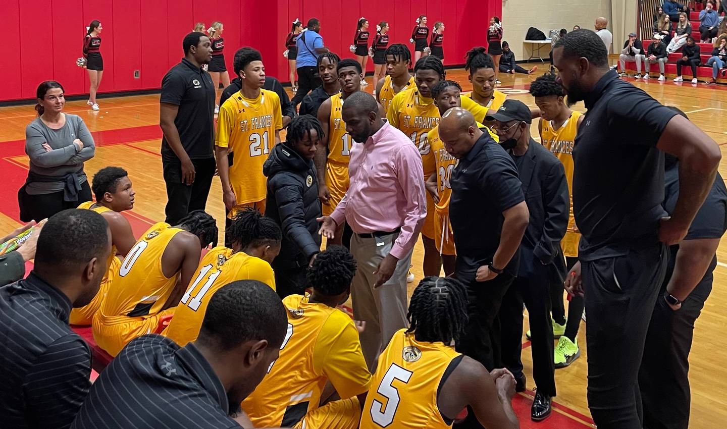 St. Frances boys basketball coach Nick Myles (center) talks to his team during Monday's Baltimore Catholic League contest against Archbishop Spalding. The No. 2 Panthers remained undefeated in BCL play with a 87-55 decision in Anne Arundel County.