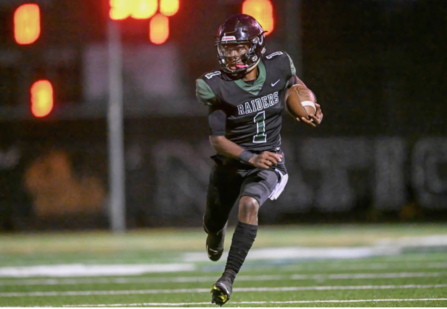 Atholton quarterback Miles Scott heads downfield in Friday's Howard County matchup with River Hill.