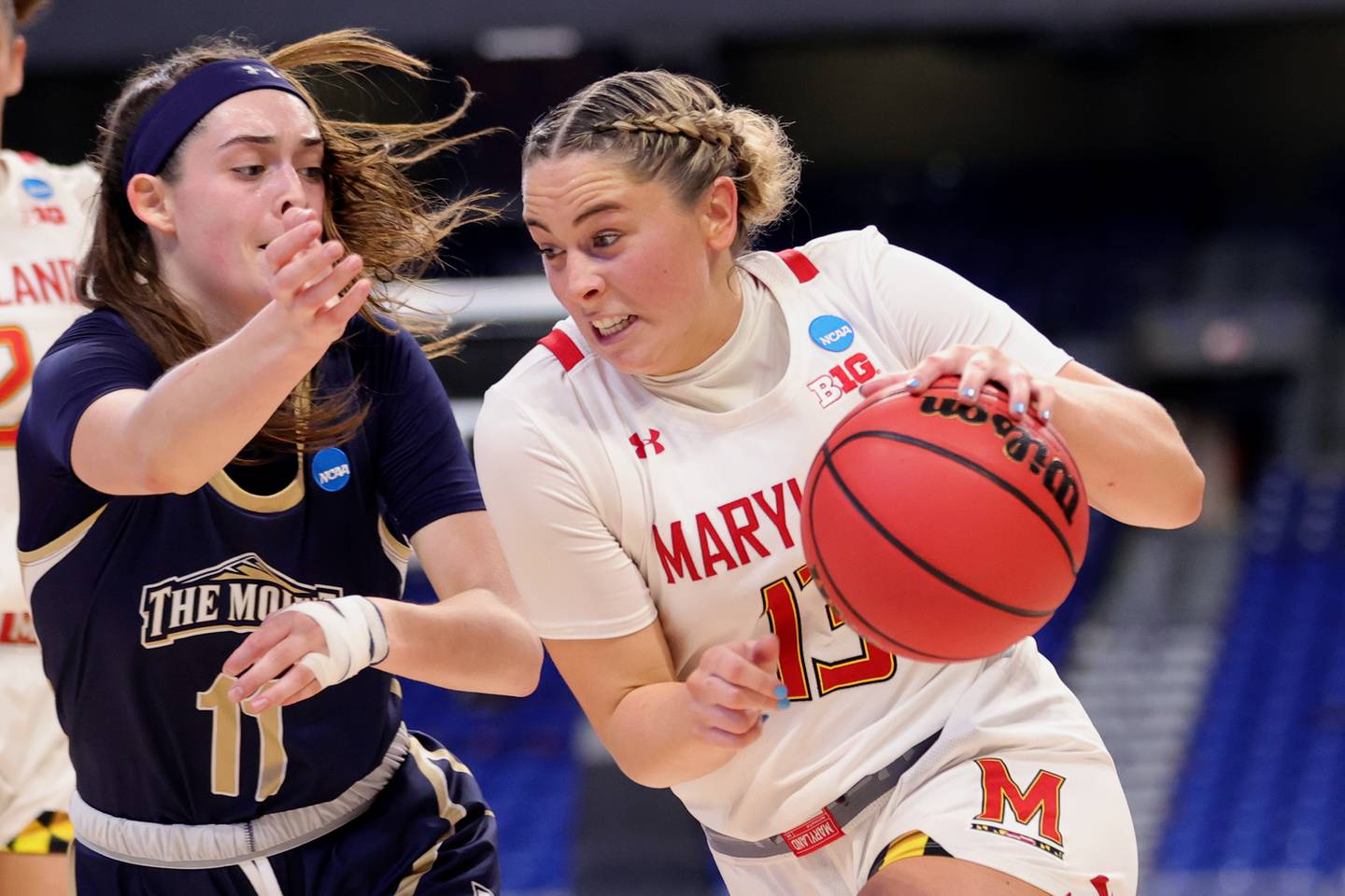 SAN ANTONIO, TEXAS - MARCH 22: Faith Masonius #13 of the Maryland Terrapins drives passed Bridget Birkhead #11 of the Mt. St. Mary's Mountaineers during the first half in the first round game of the 2021 NCAA Women's Basketball Tournament at the Alamodome on March 22, 2021 in San Antonio, Texas.