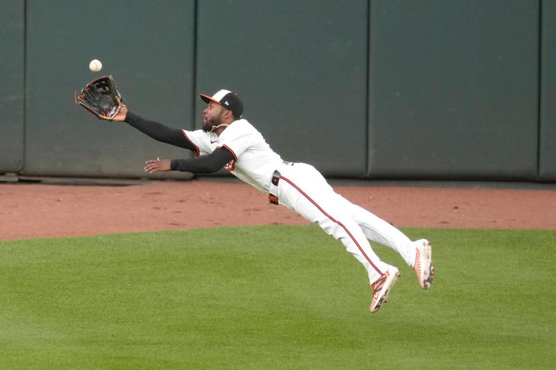 BALTIMORE, MARYLAND - APRIL 15:  Cedric Mullins #31 of the Baltimore Orioles catches a fly ball hit byByron Buxton #25 if the Minnesota Twins in the first inning during a baseball game at Oriole Park at Camden Yards on April 15, 2024 in Baltimore, Maryland.  All players are wearing the number 42 in honor of Jackie Robinson Day.  (Photo by Mitchell Layton/Getty Images)