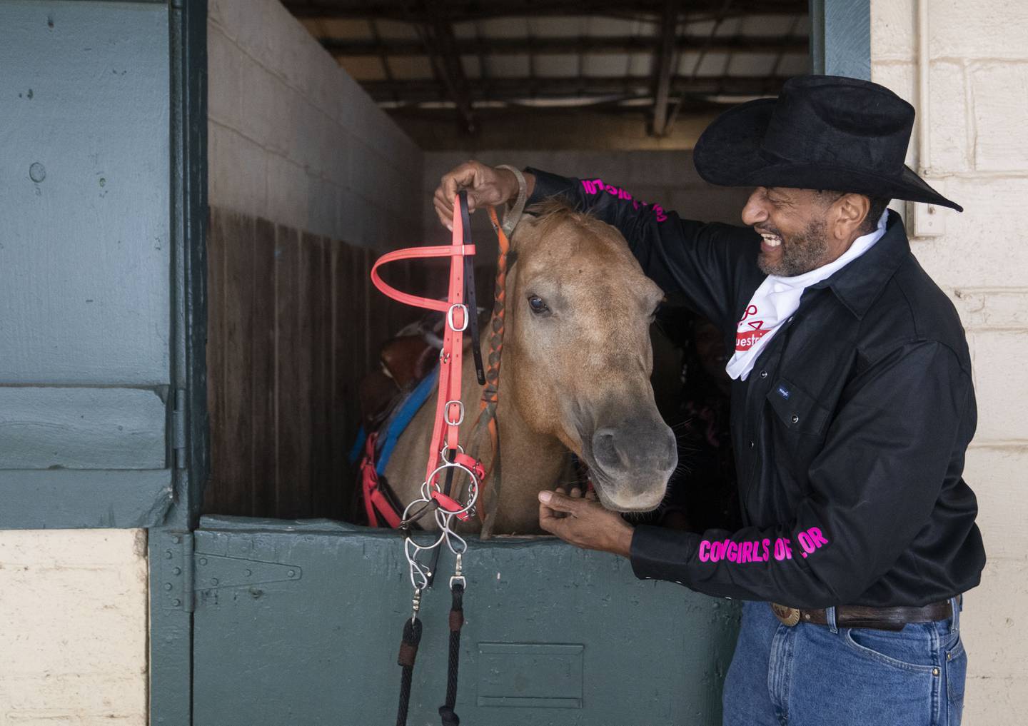 Ray Lockamy, coach of the Cowgirls of Color, helps prepare a horse for the group before they compete in the Bill Pickett Invitational Rodeo, at The Show Place Arena, in Upper Marlboro, MD, Saturday, September 23, 2023. a