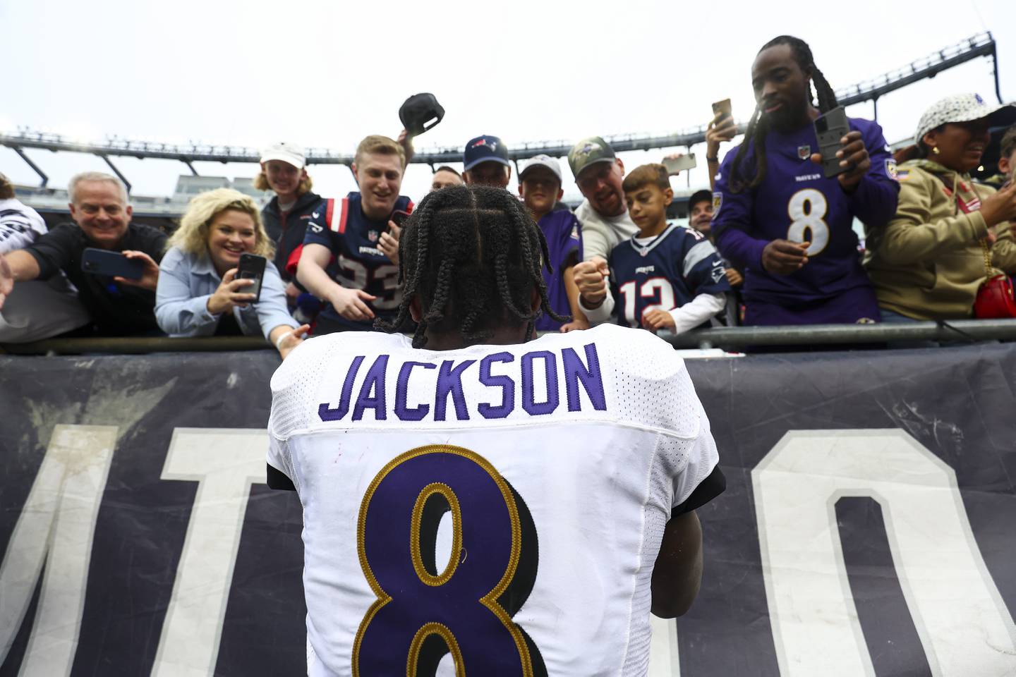 FOXBOROUGH, MASSACHUSETTS - SEPTEMBER 25: Quarterback Lamar Jackson #8 of the Baltimore Ravens celebrates with fans after his team's 37-26 win over the New England Patriots at Gillette Stadium on September 25, 2022 in Foxborough, Massachusetts.