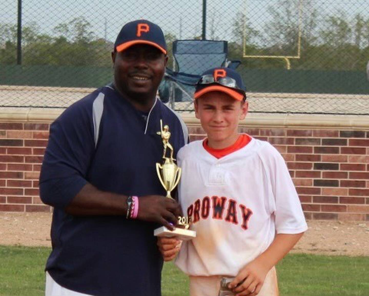 Colton Cowser, as a young teenager, poses with longtime hitting coach Sid Holland.