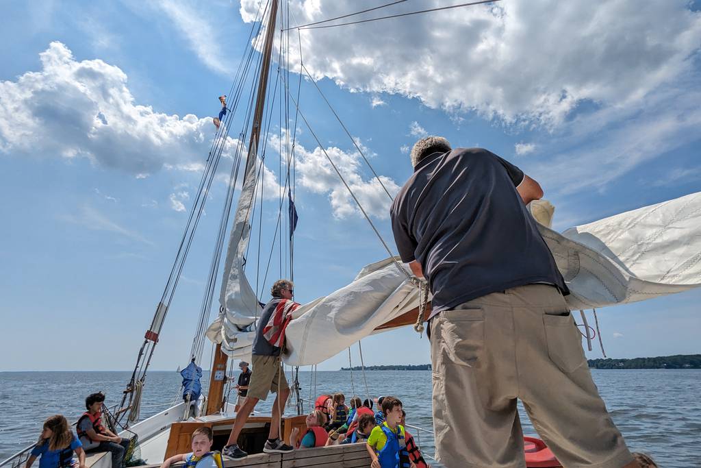 Volunteer crew Brian Fleming, left, and Philip Smith stow the mainsail aboard the Wilma Lee, an 83-year-old skipjack operated by the Annapolis Maritime Museum & Park.