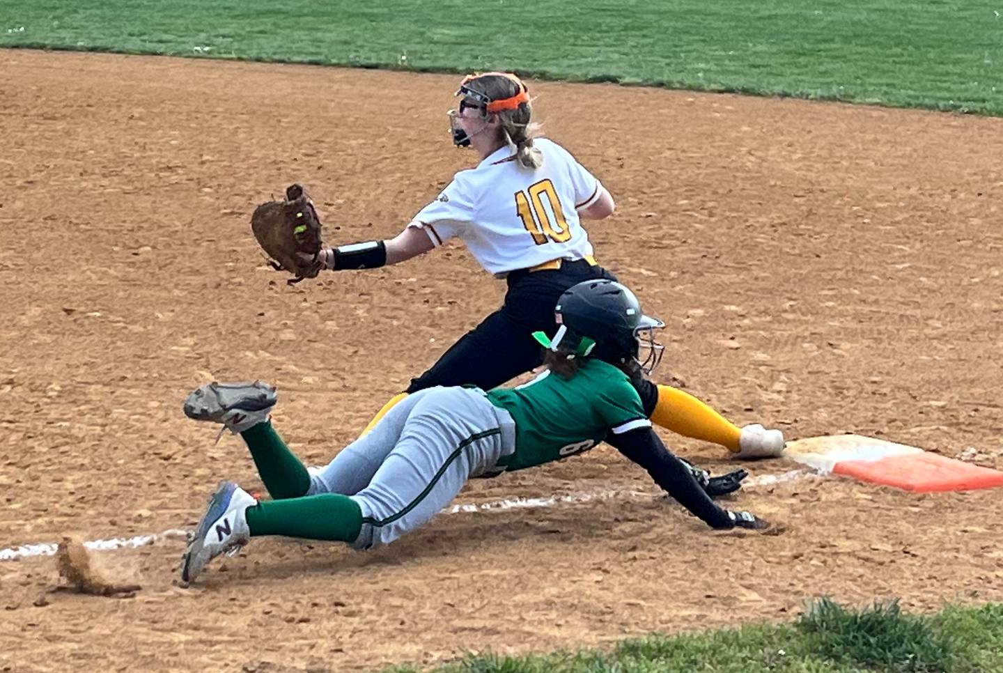 Arundel's Bria Sewell dives for first base as Northeast first basemen Mackenzie Weiland has the ball for the out during the third inning of Monday's Anne Arundel County softball contest. The Eagles improved to 11-1 with a 4-1 victory in Pasadena.